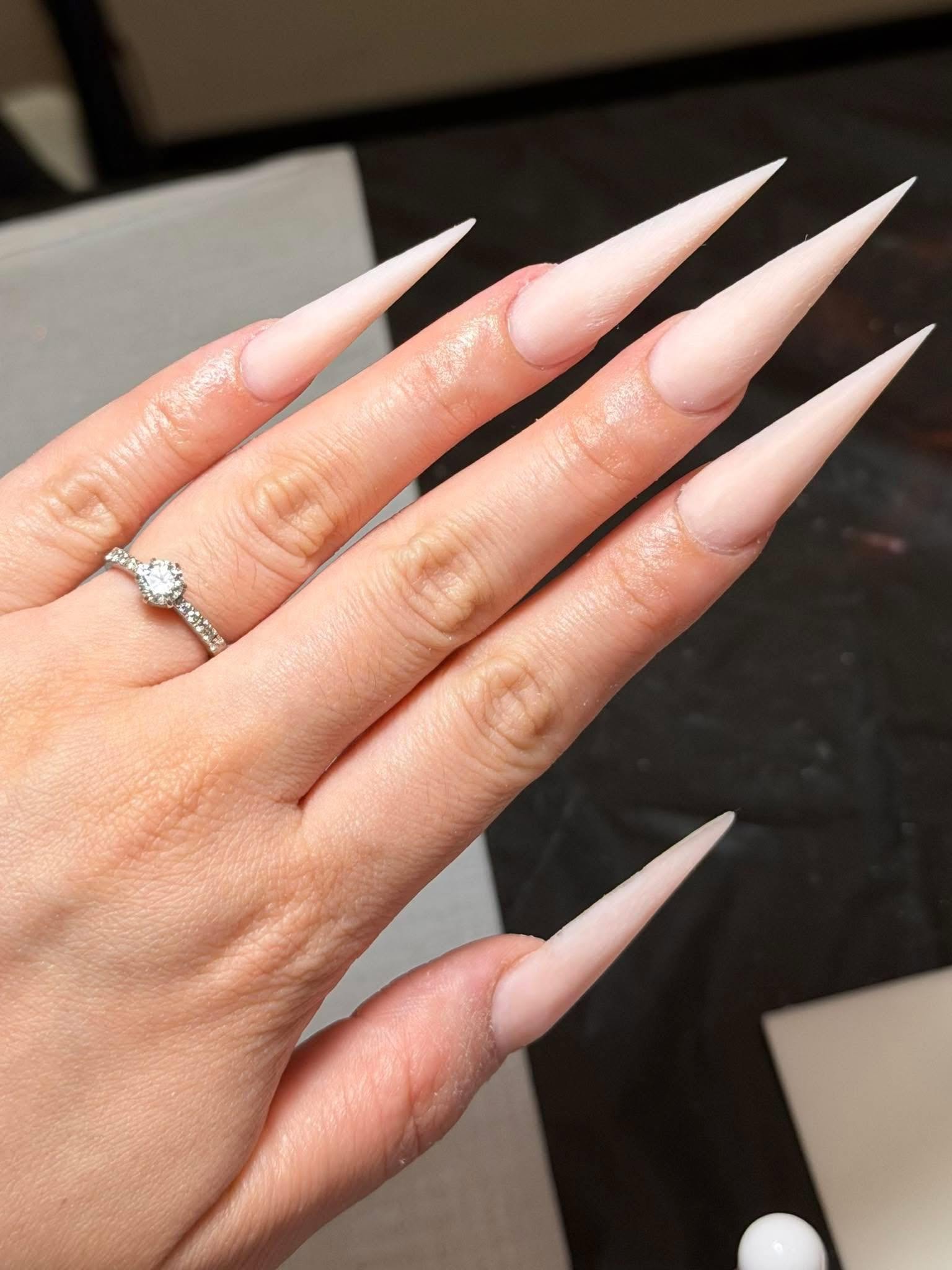 Extra-long pale nude stiletto acrylic extensions