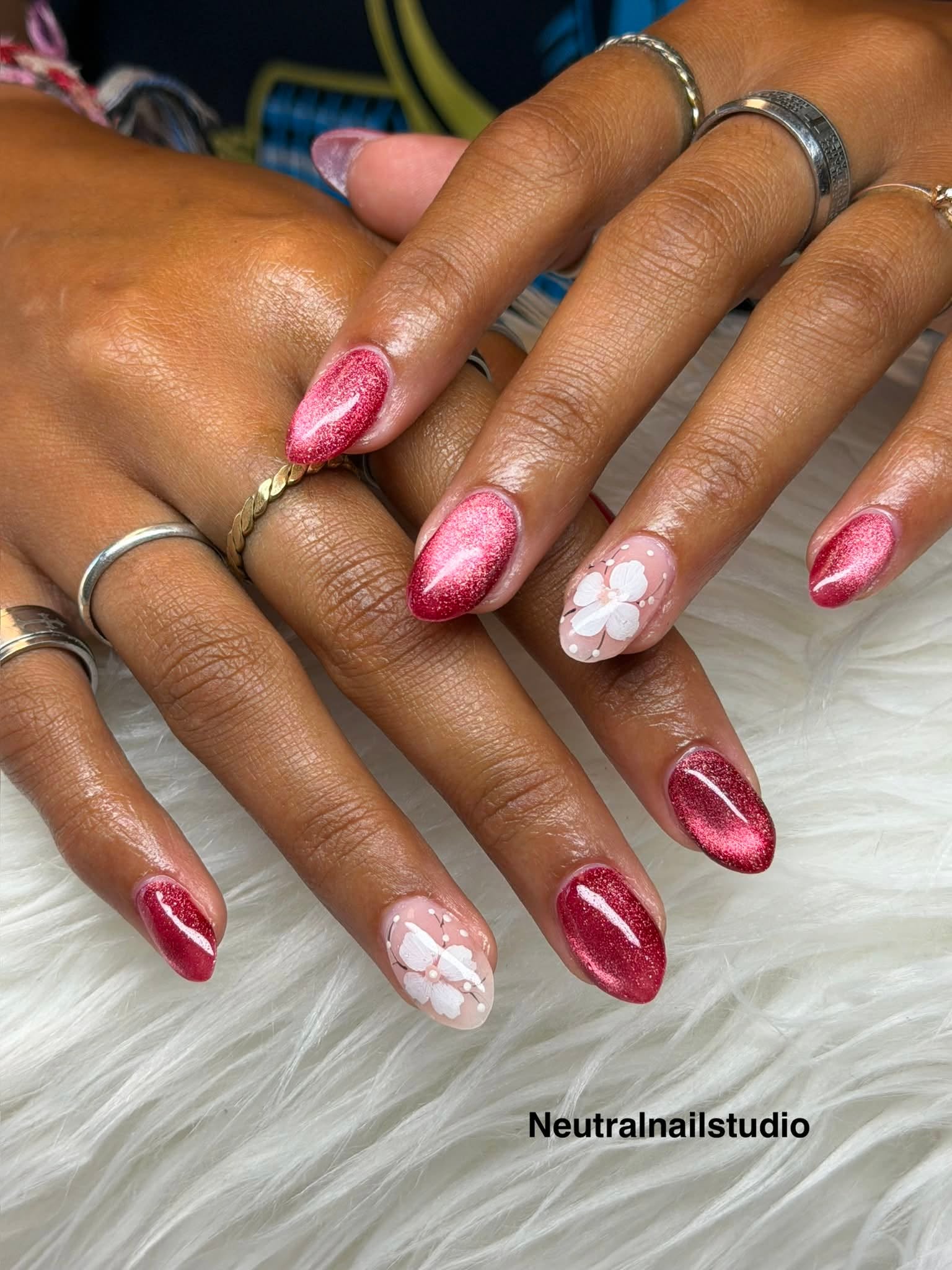 Sparkling burgundy glitter nails with white flower accents