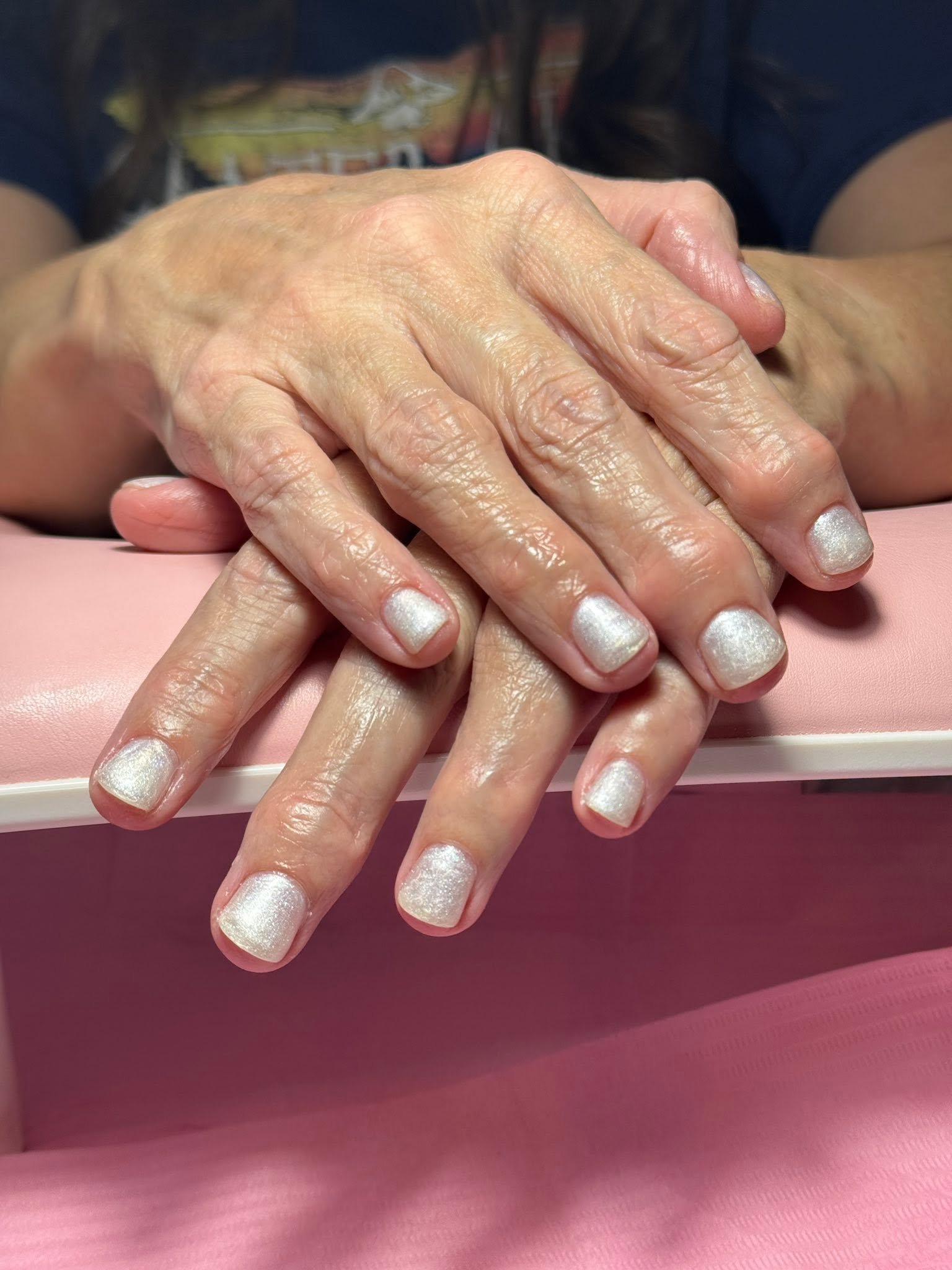 Pearlescent white shimmer manicure with metallic sparkle