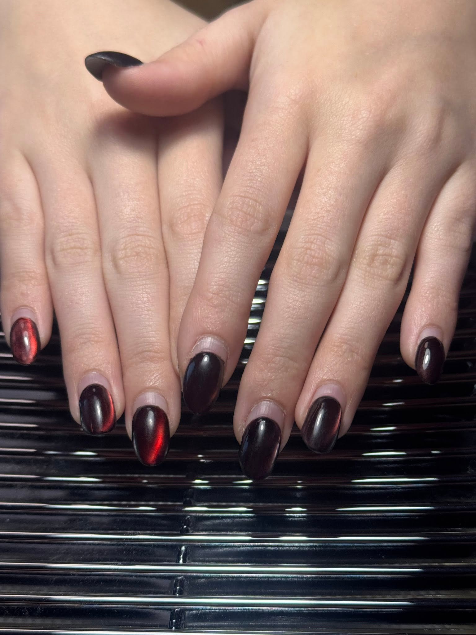 Dark red and black cat-eye chrome nails