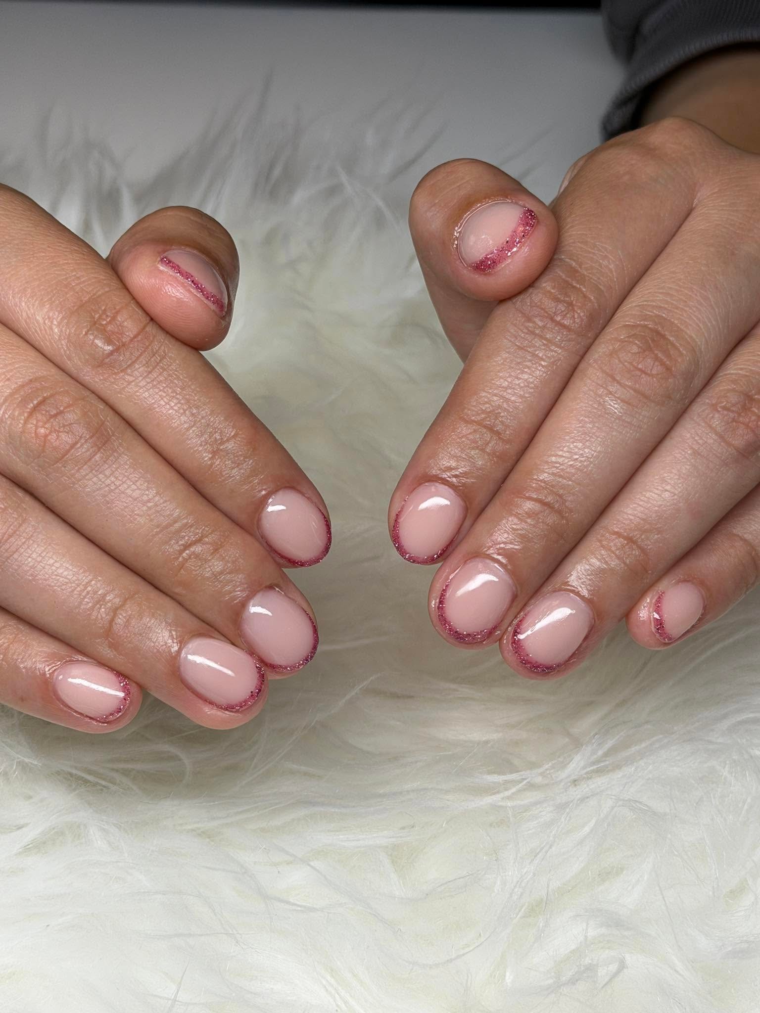 Nude nails with pink glitter French tips