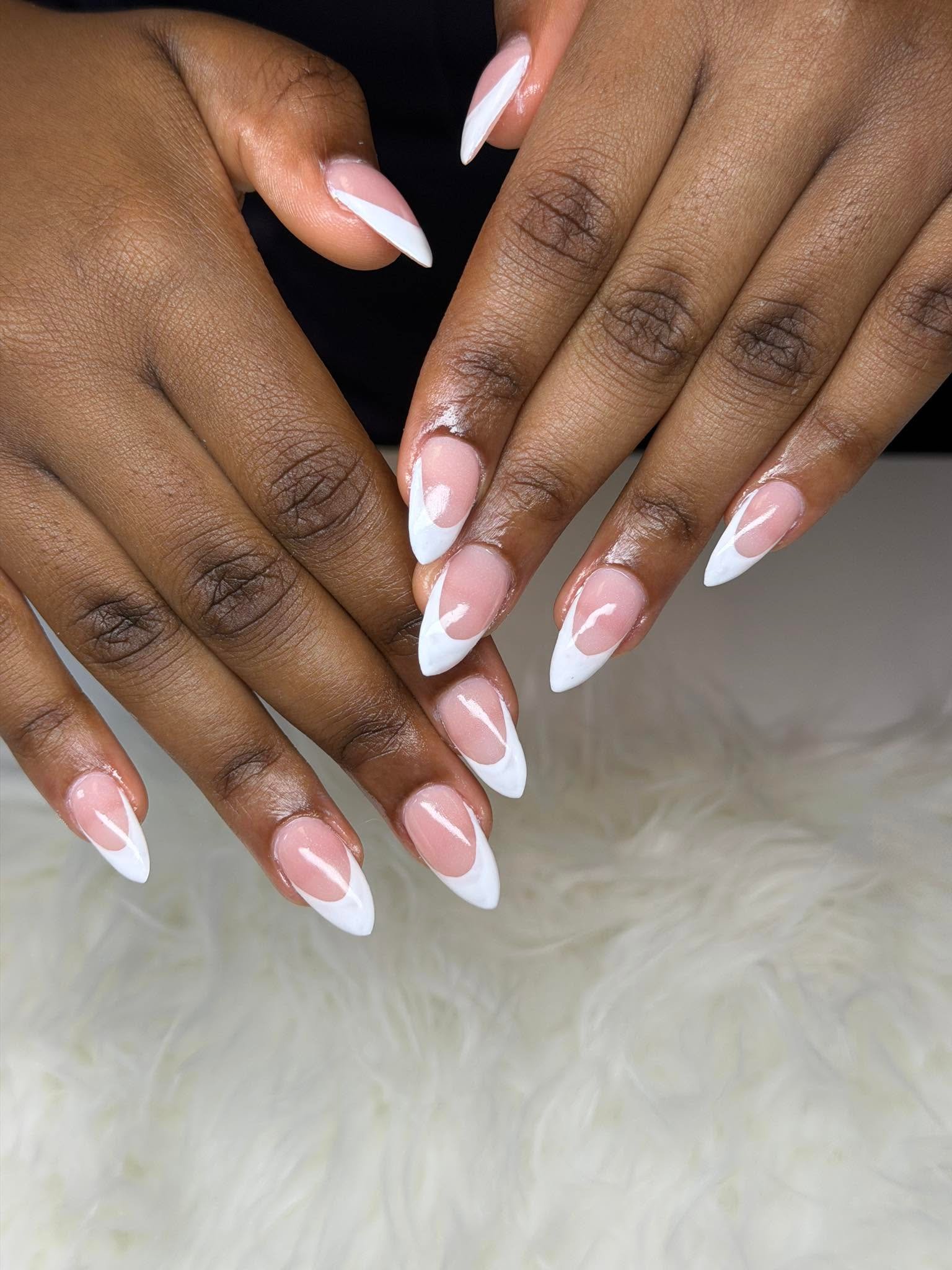 Sharp white French tips on an almond nail shape