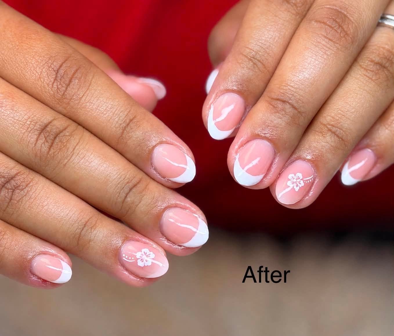 Classic white French tip manicure with a small cherry blossom accent nail