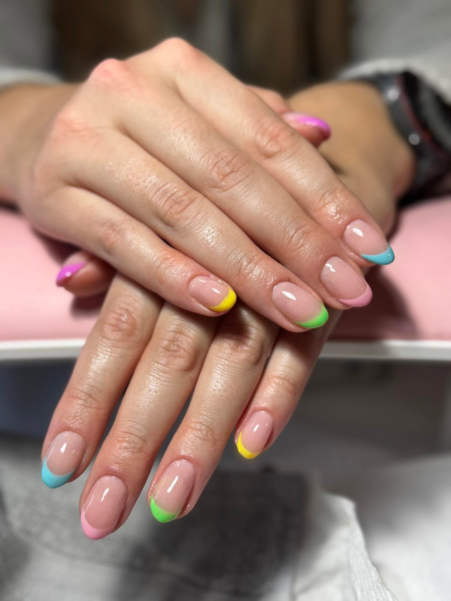Colorful rainbow French tip manicure with yellow, green, pink and blue lines