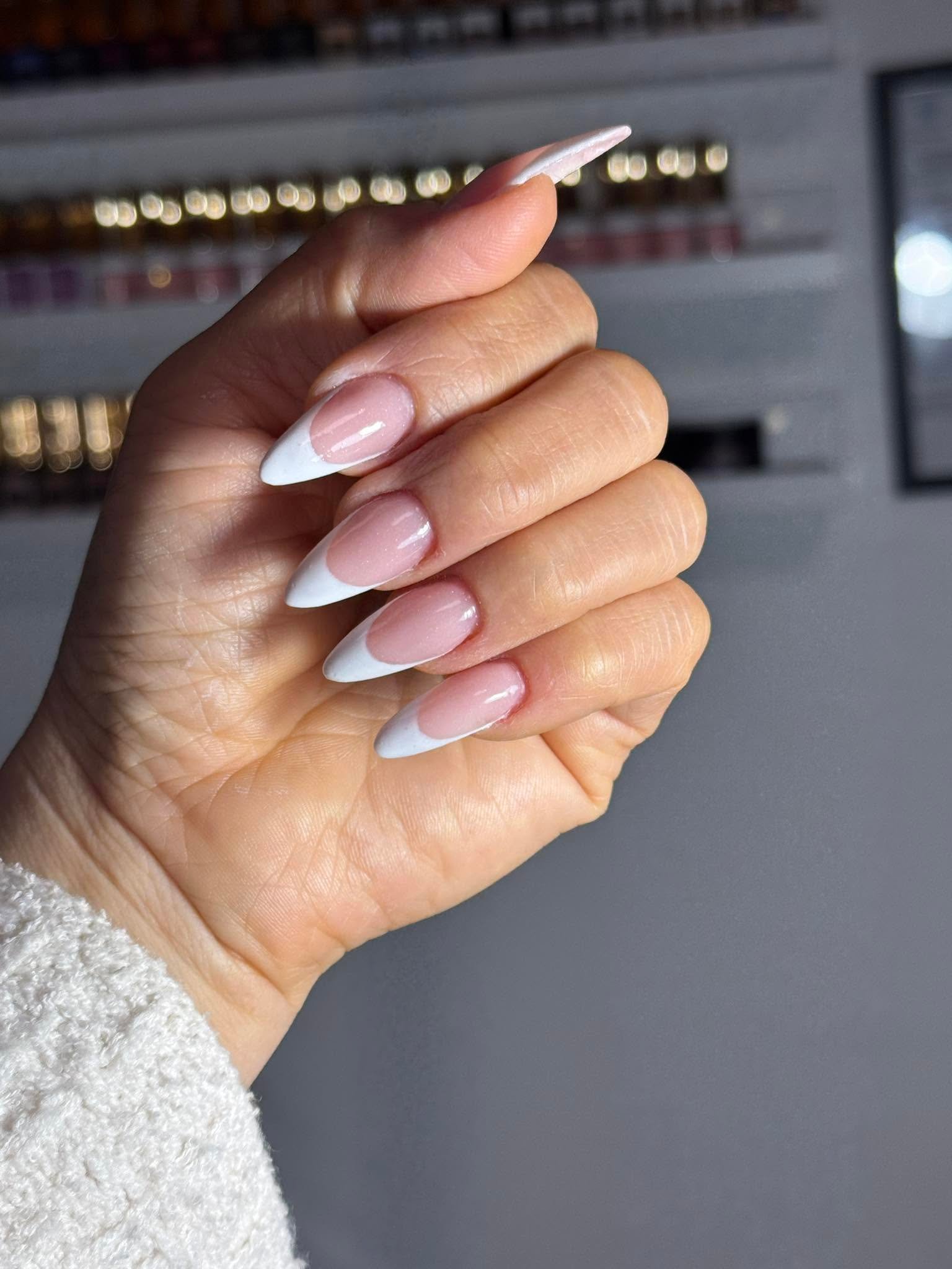 Classic white-tip French manicure on almond nails