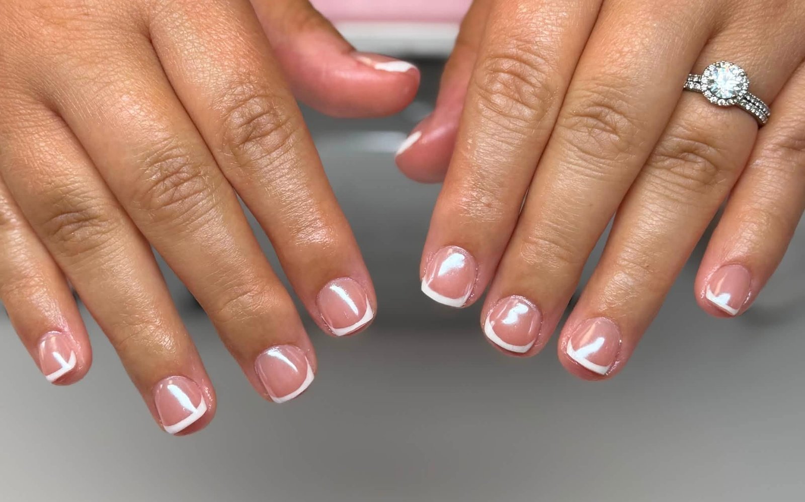 Classic white French manicure with diamond ring