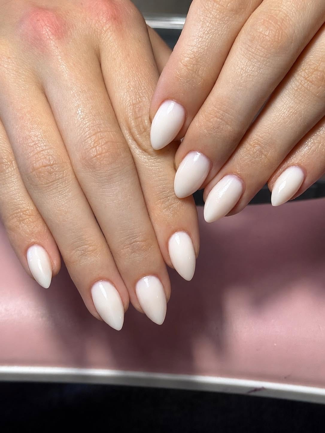 Milky white solid gel manicure on almond nails