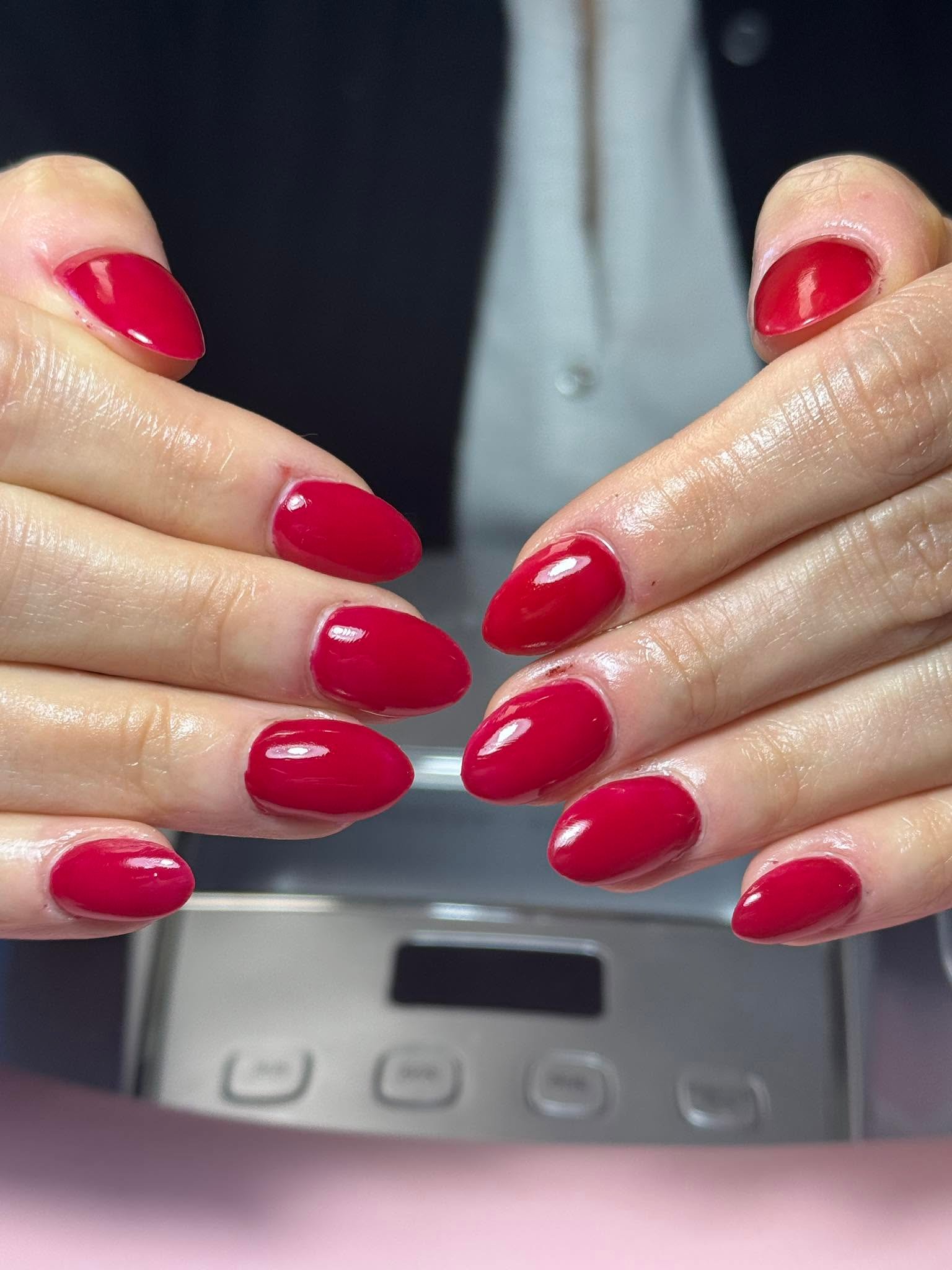 Glossy red almond-shaped solid gel manicure