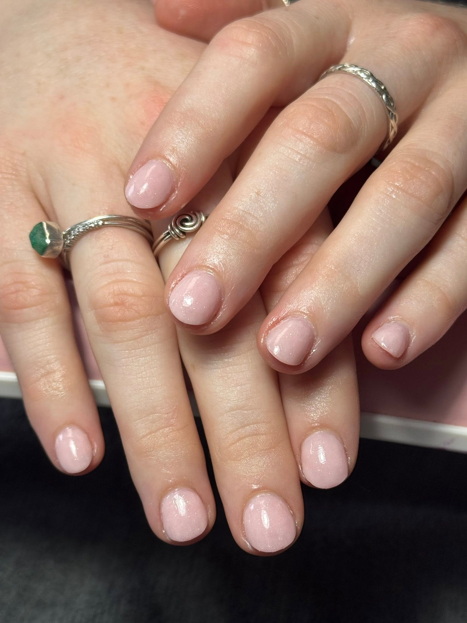 Sheer shimmer pink gel manicure with silver rings