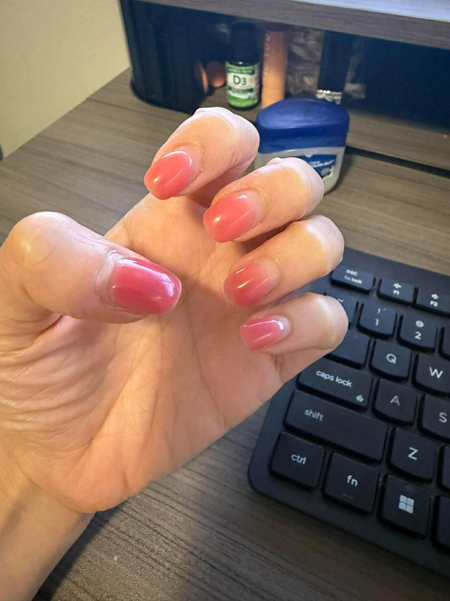 Coral pink solid gel manicure with glossy shine