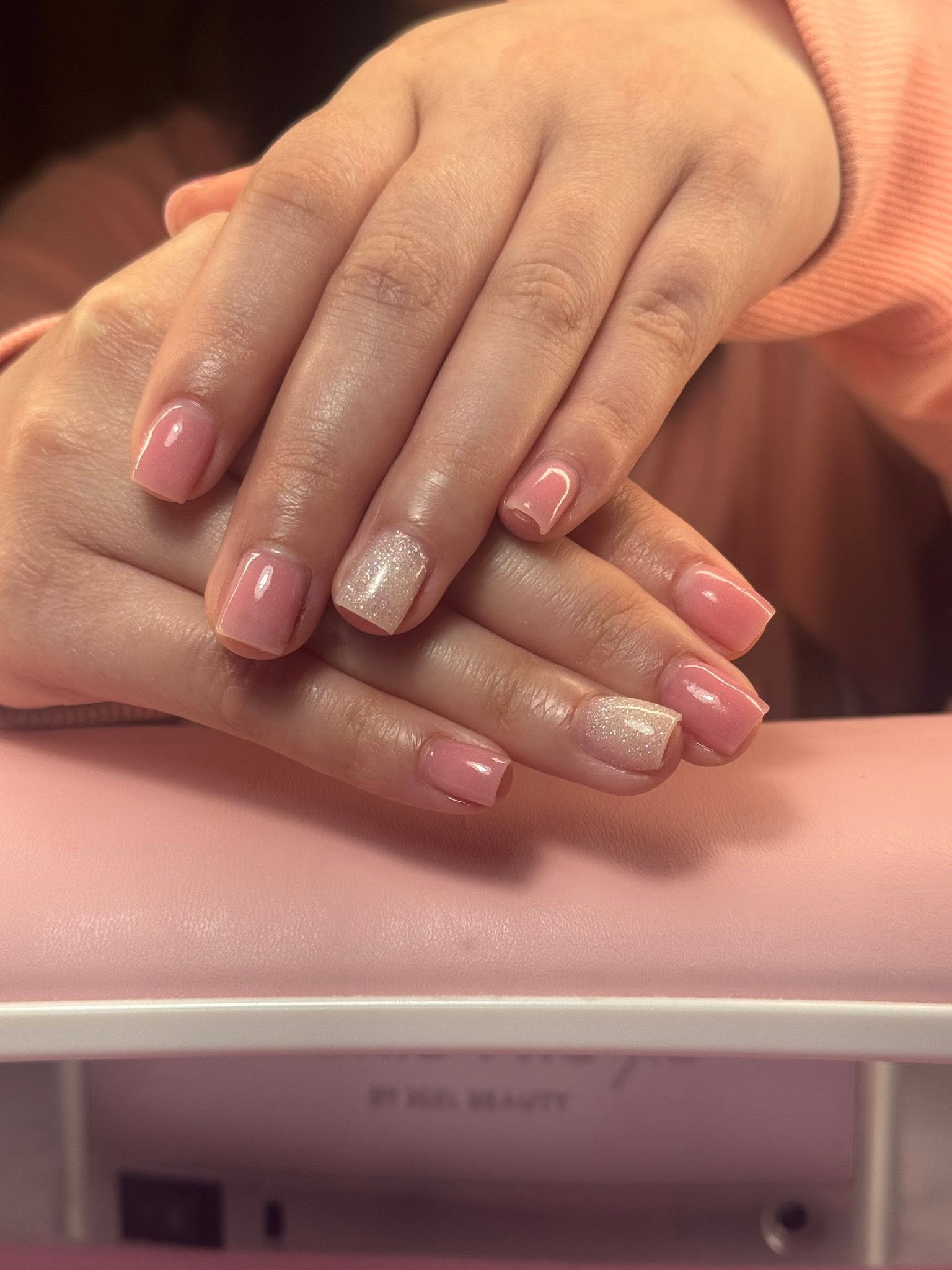 Blush pink glossy nails with a glitter accent nail