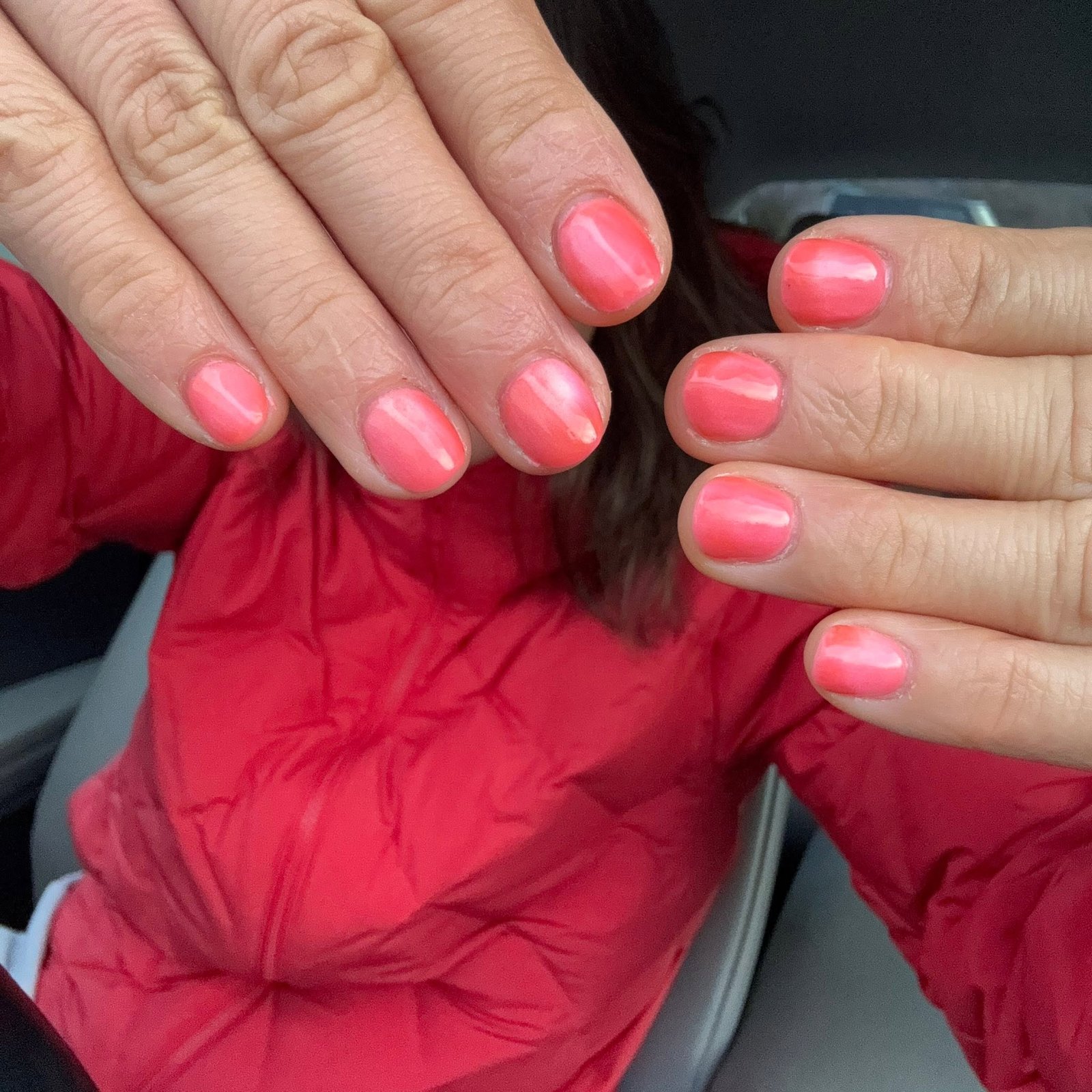 Coral pink glossy gel manicure