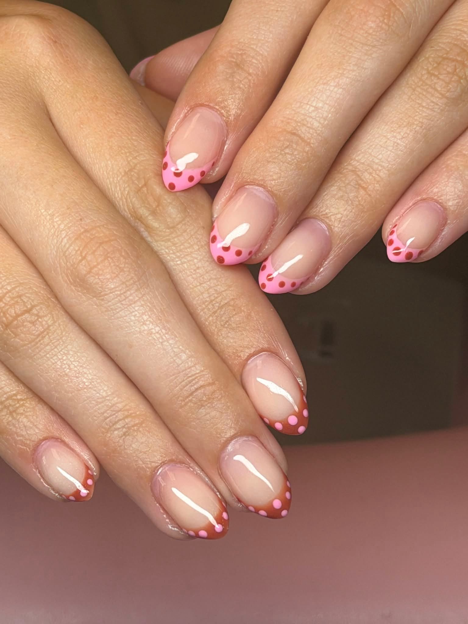 Nude nails with pink and brown polka dot French tips