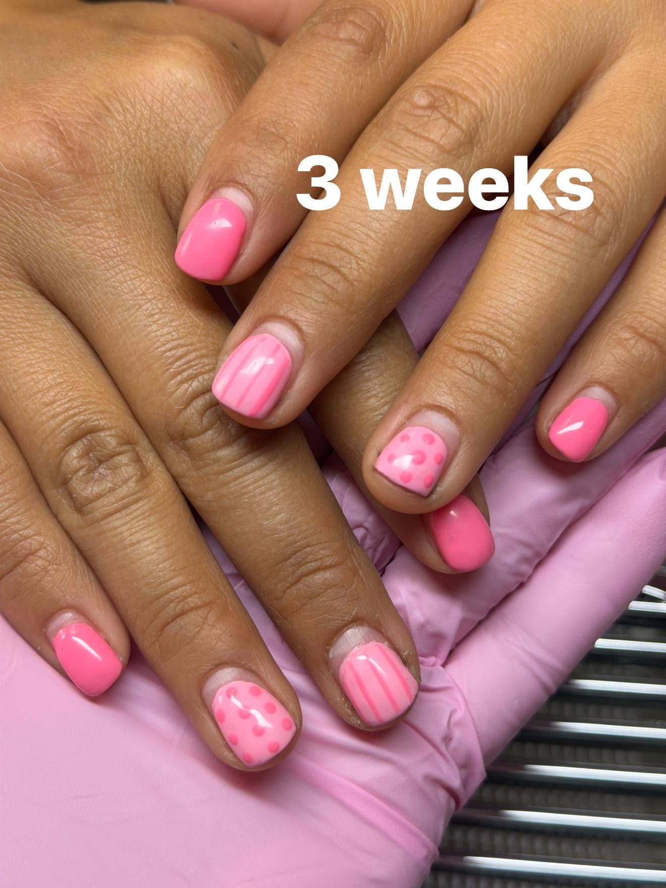 Pink gel nails with a dotted accent nail