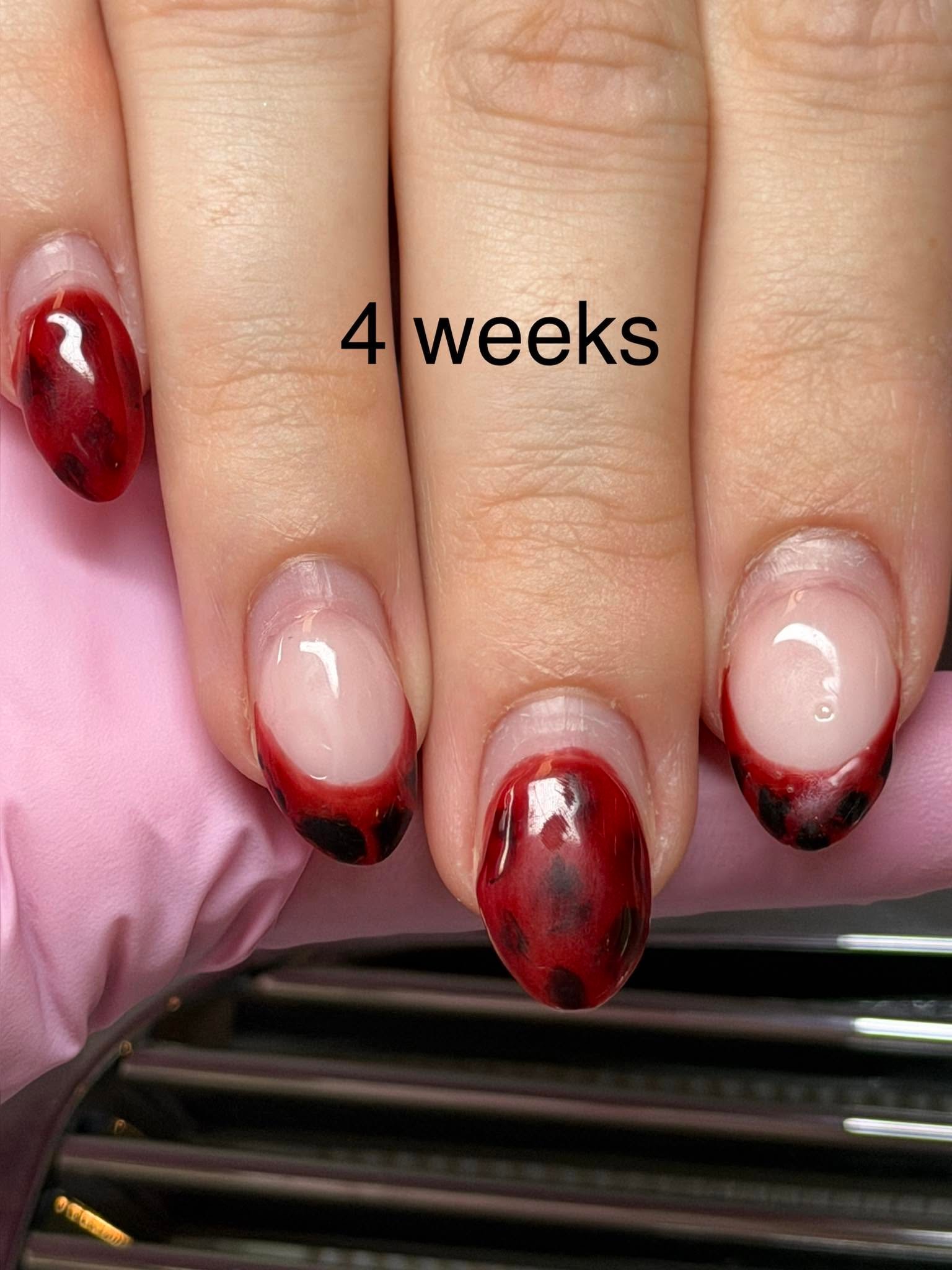 Deep red nails with a black leopard print pattern