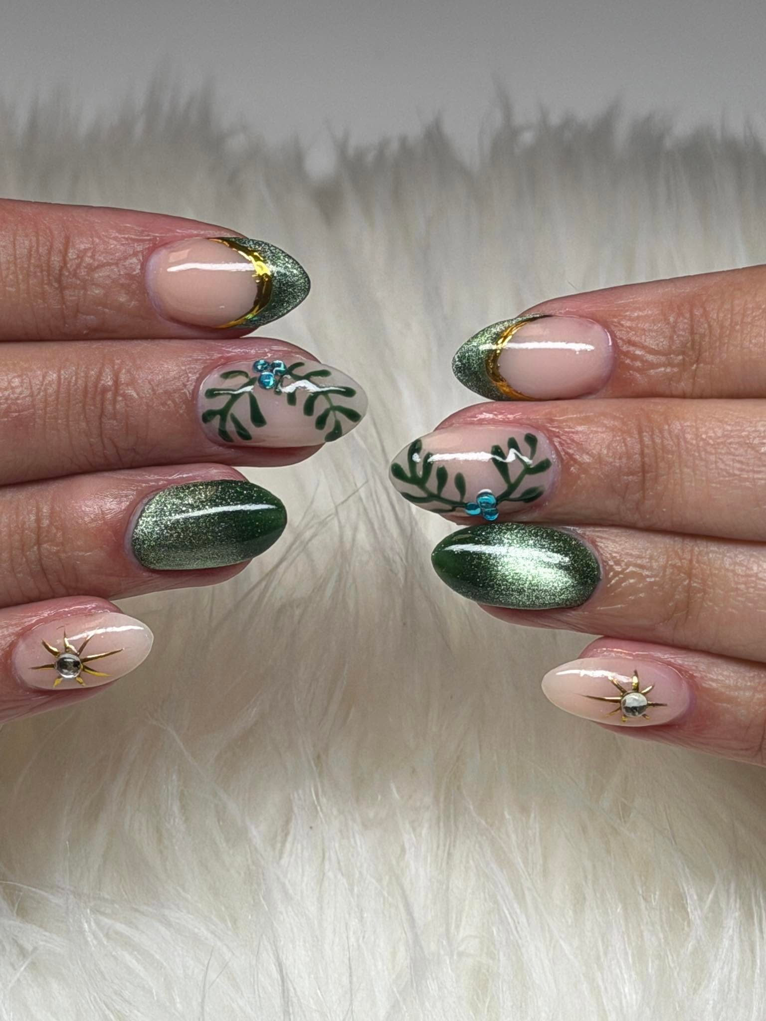 Green glitter nails with hand-painted leaf and rhinestone accents