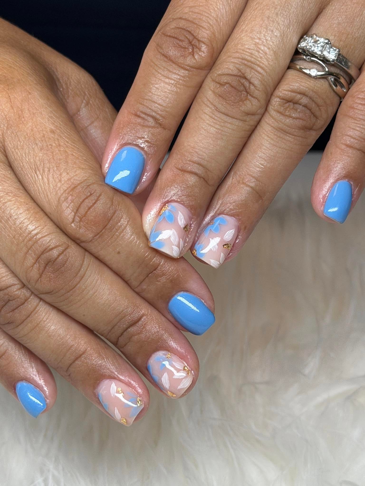 Blue nails with gold foil floral accents