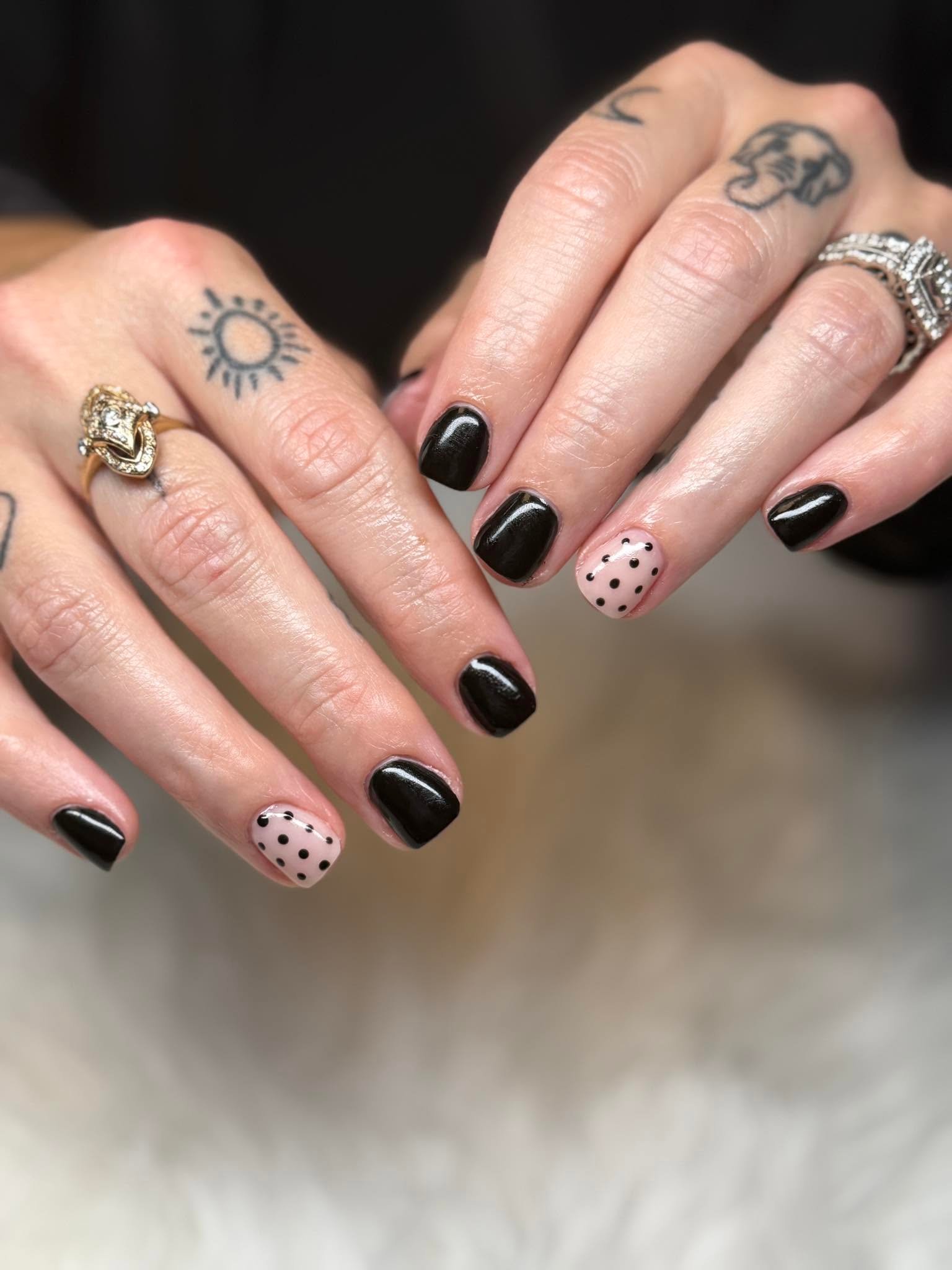 Glossy black nails with a polka dot accent nail