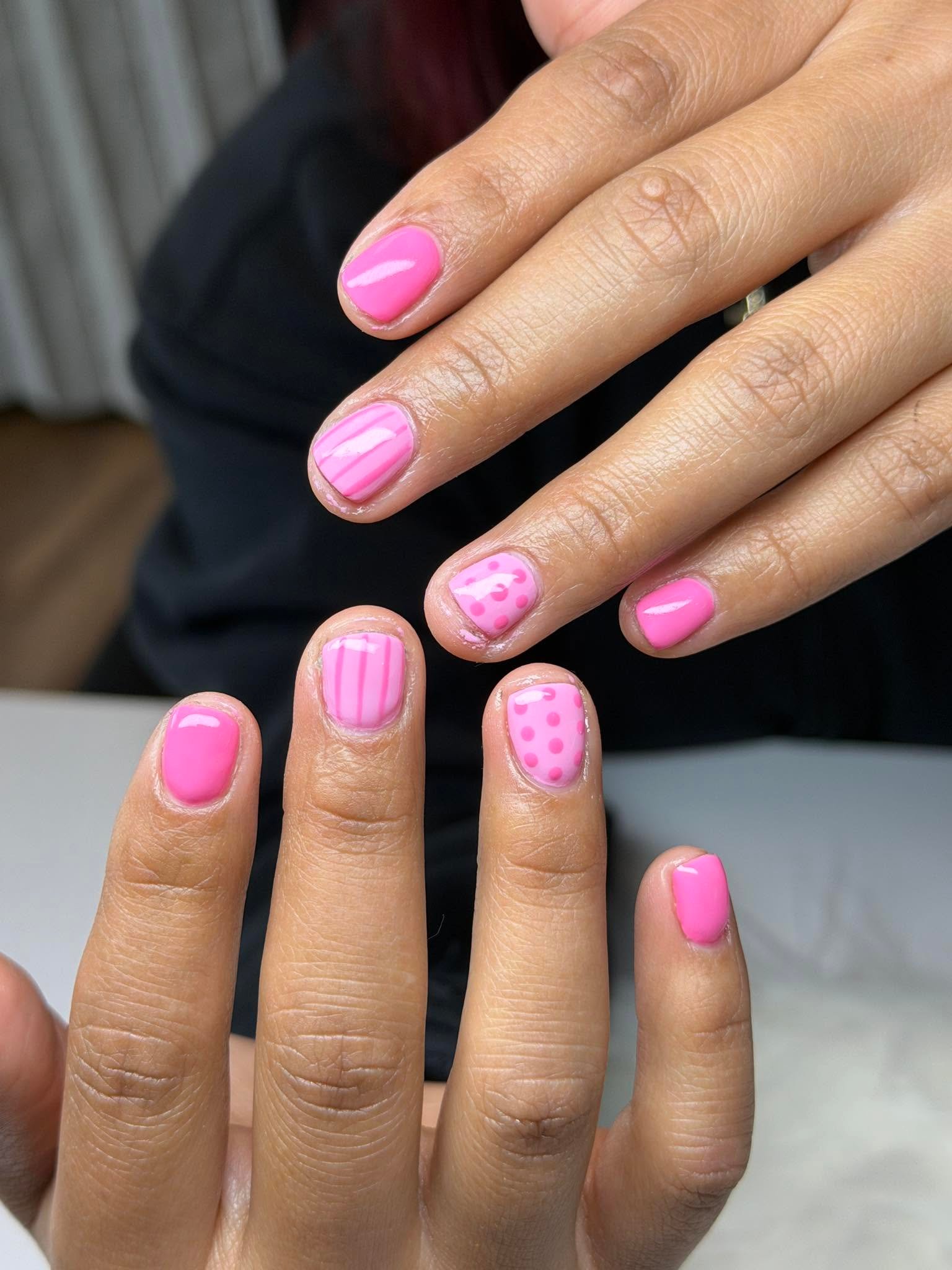 Pink manicure mixing stripes, polka dots, and solid color