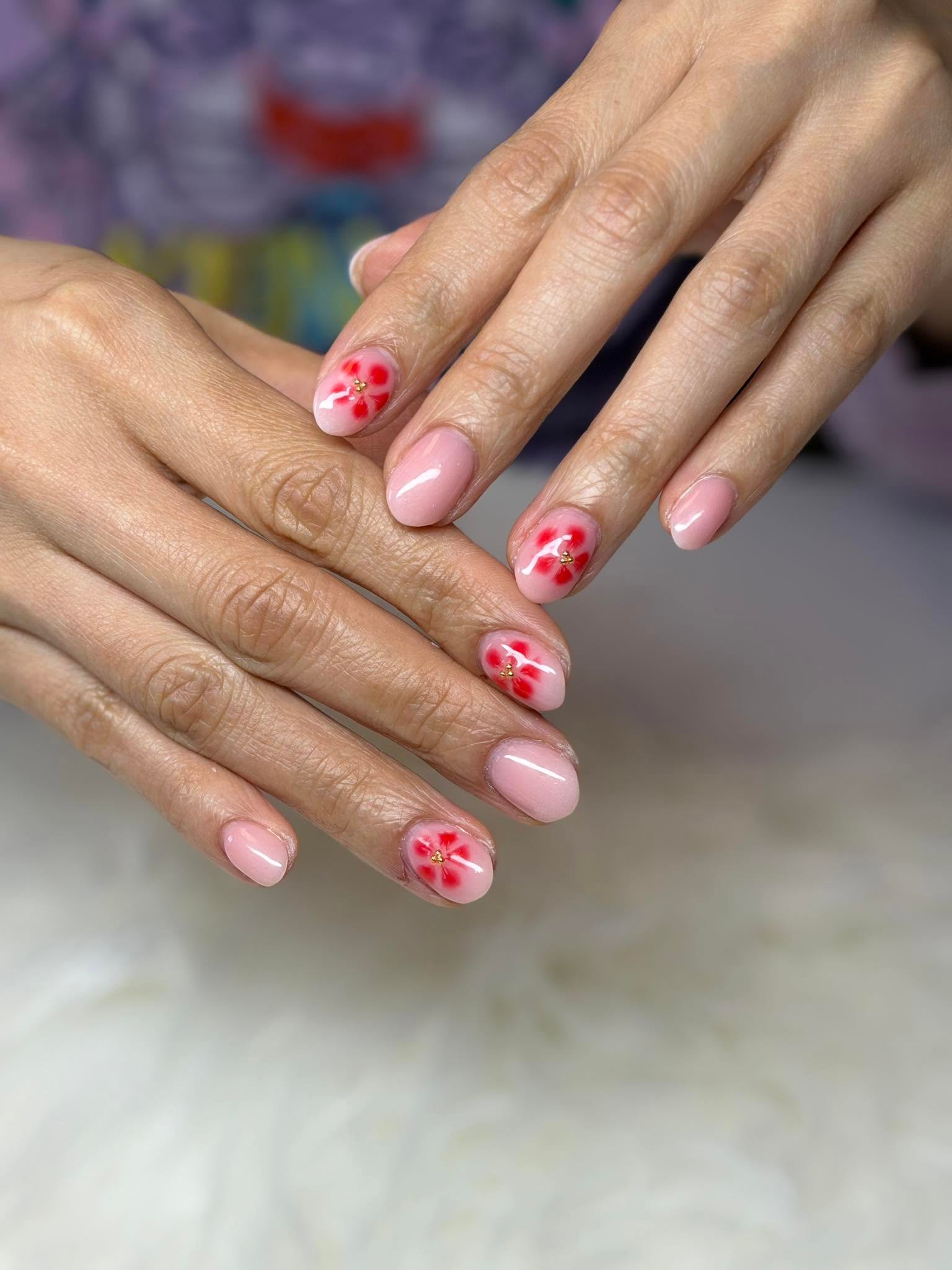Nude nails with delicate red flower nail art