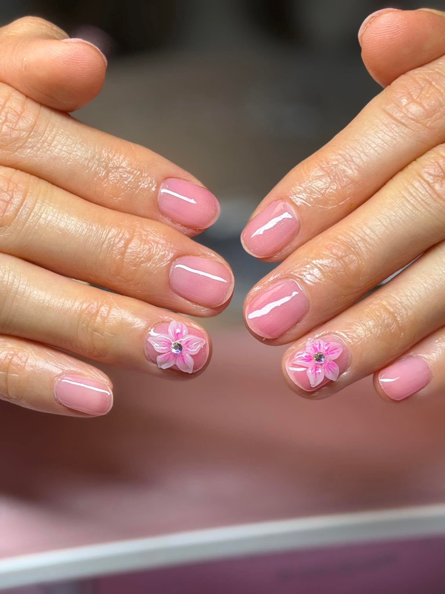 Mauve nails with 3D pink flower and rhinestone accents