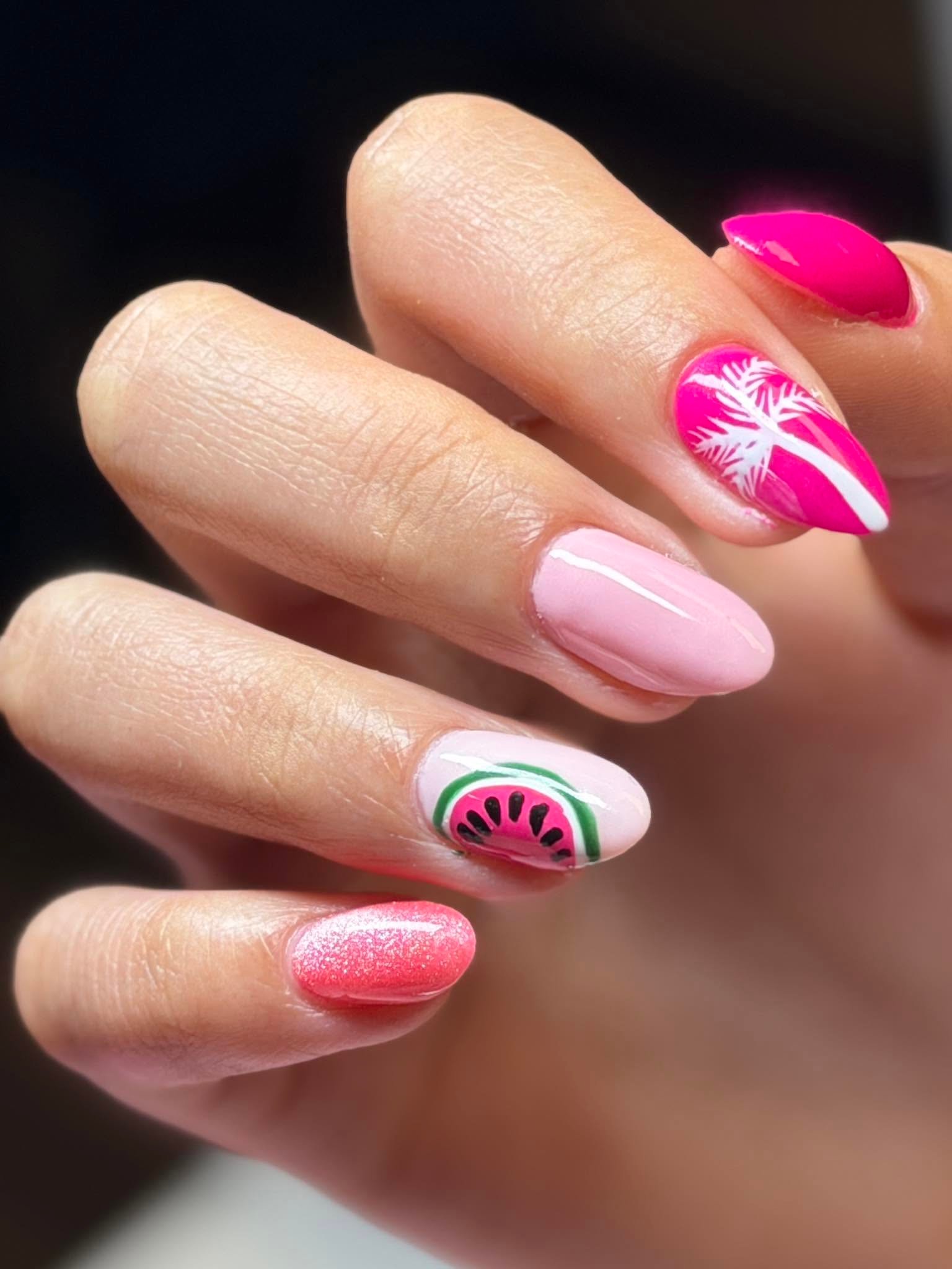 Summer-themed pink nails with palm tree and watermelon art