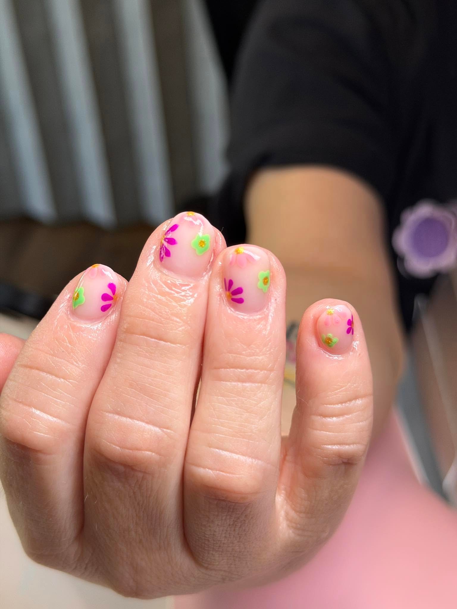 Nude nails with colorful hand-painted flowers