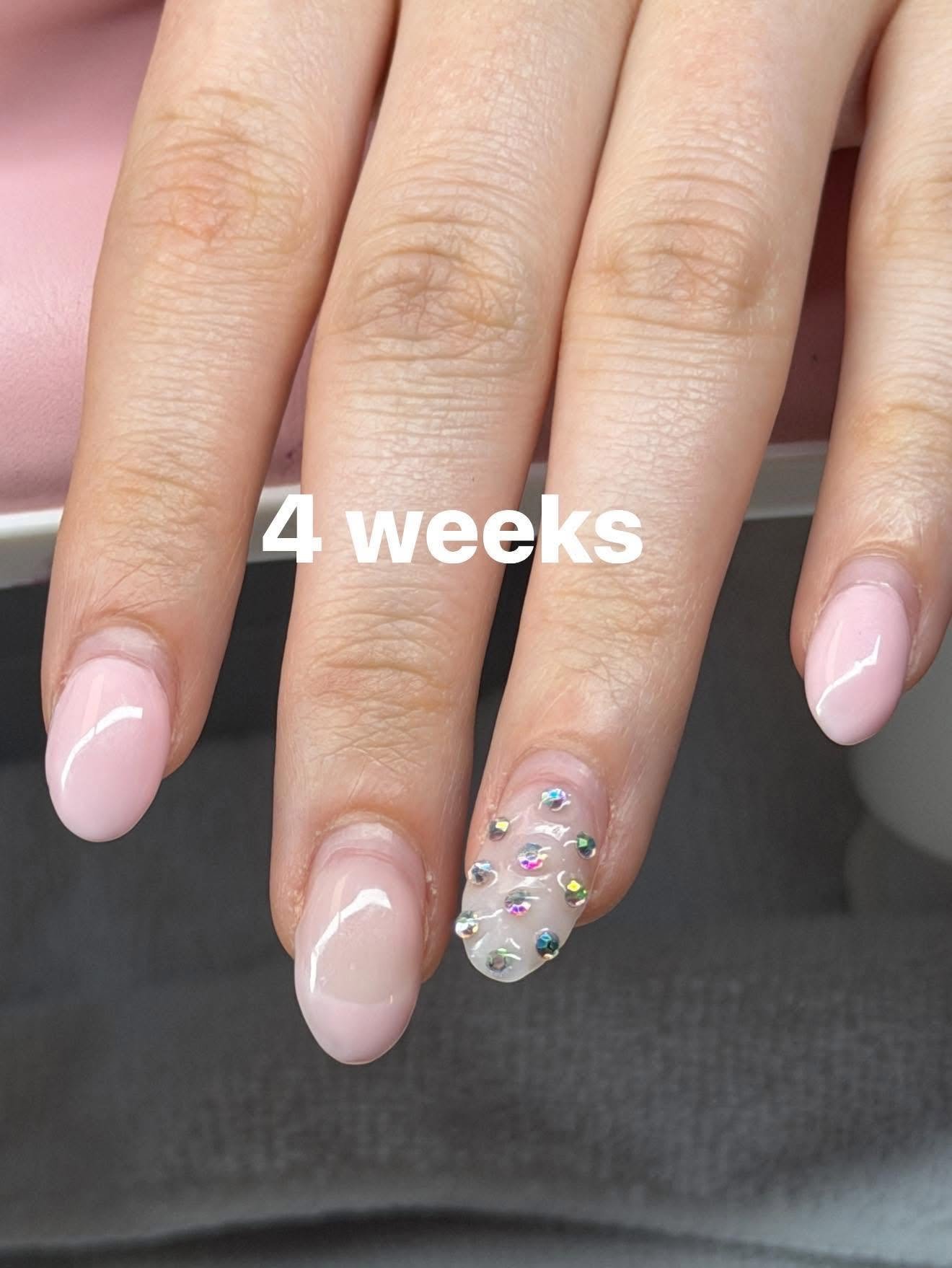 Nude nails with an iridescent rhinestone accent nail