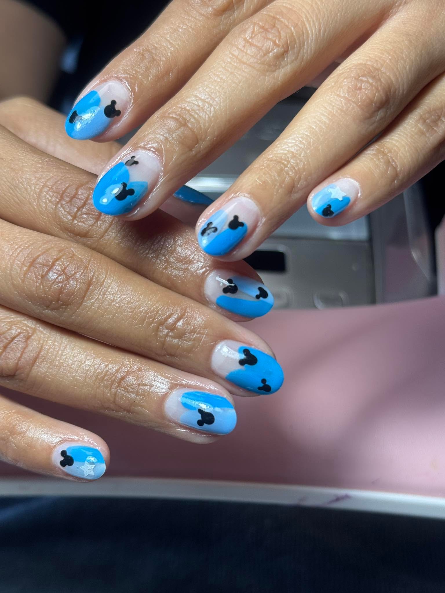 Blue nails with hand-painted Mickey Mouse silhouette design