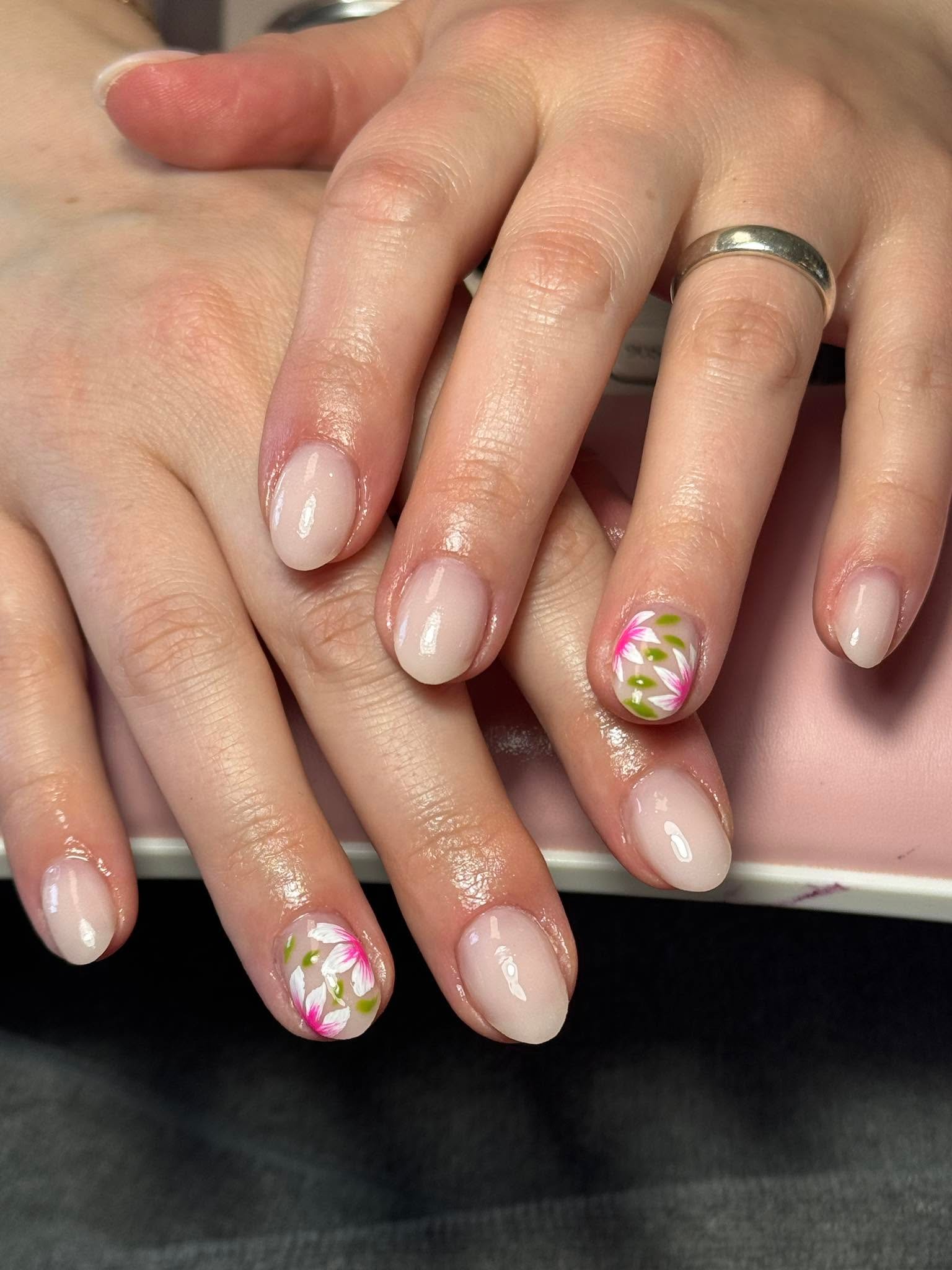 Nude nails with a pink and white floral accent nail