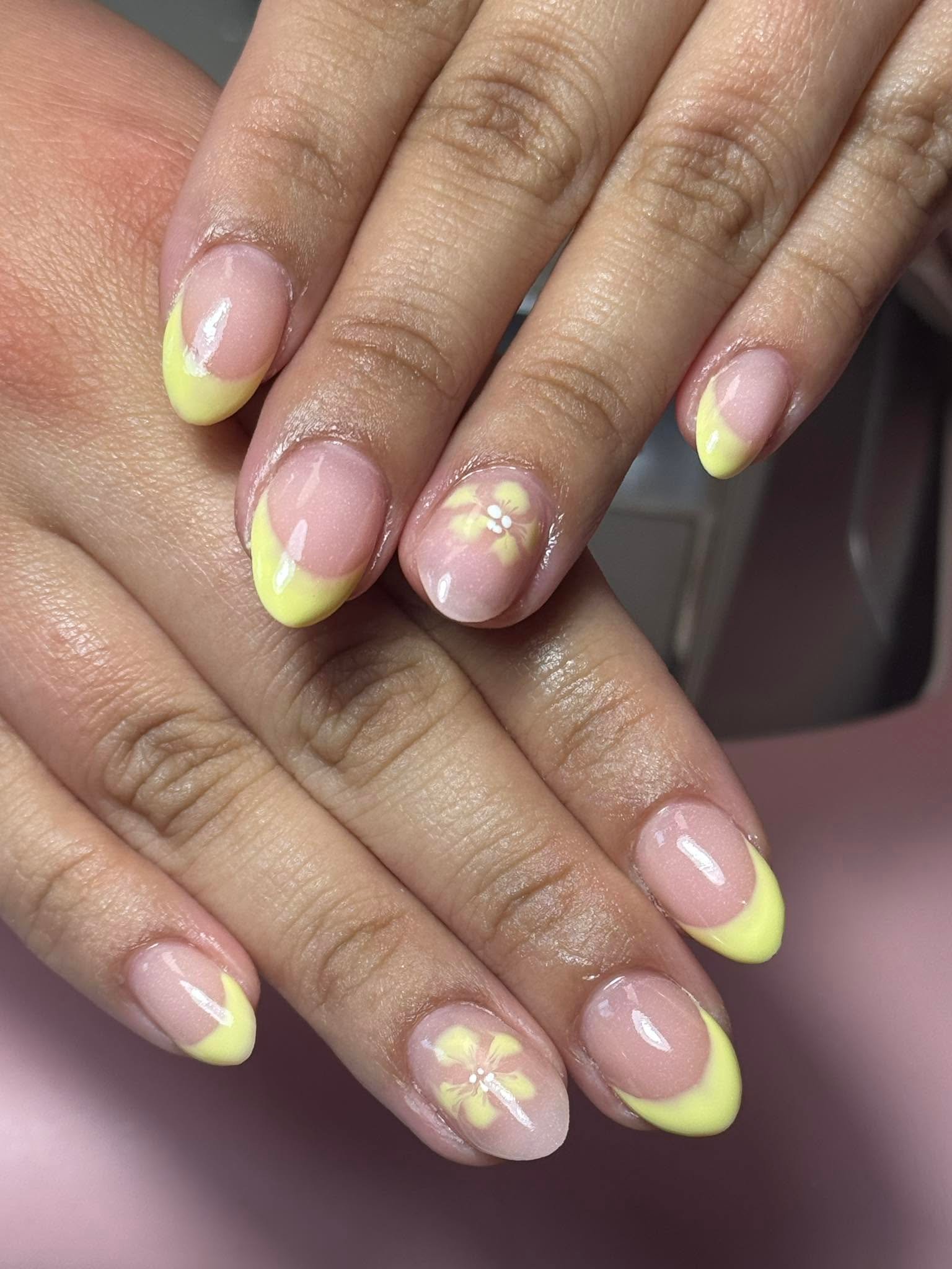 Yellow French tips with a hand-painted flower accent