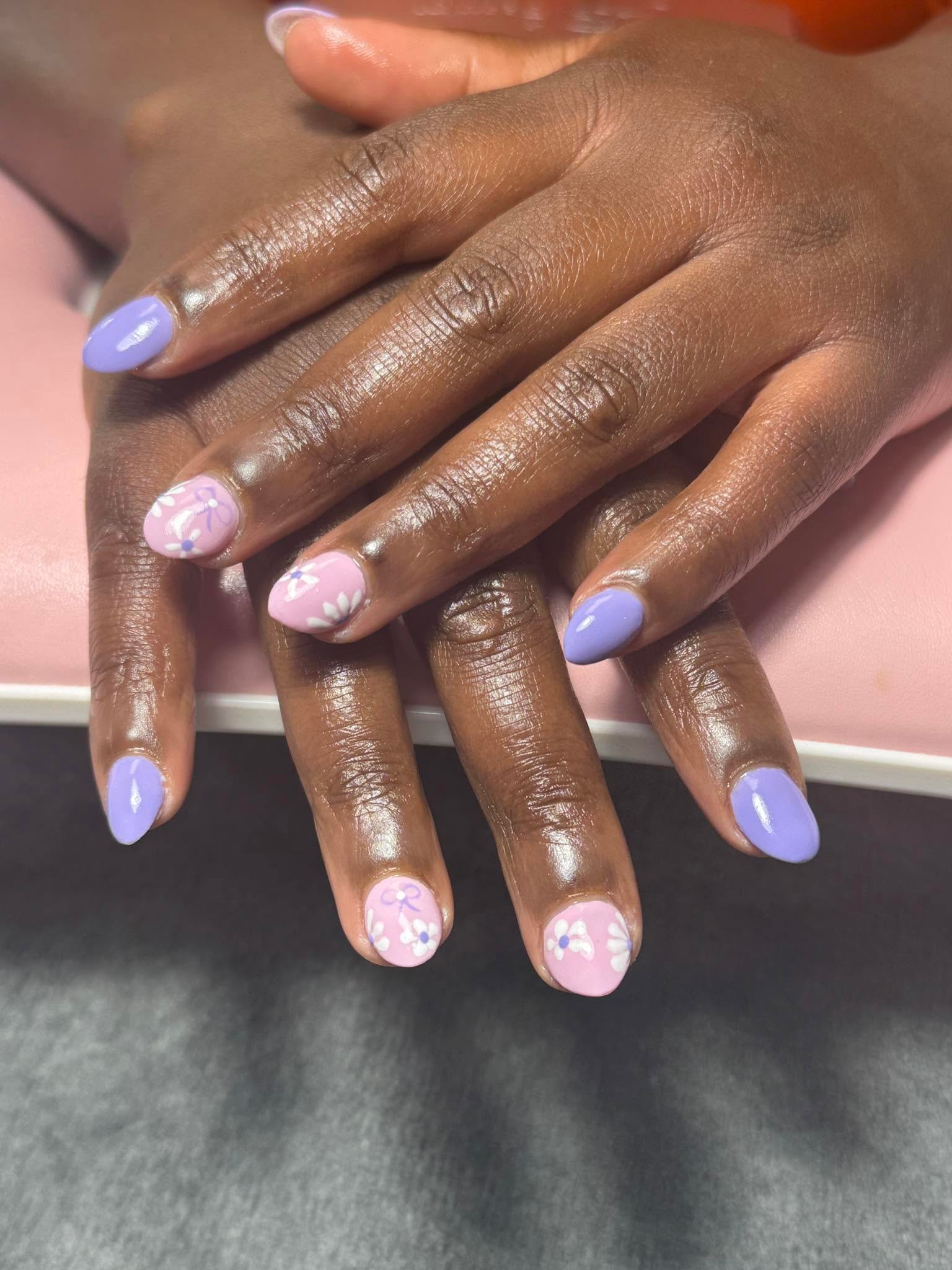 Lavender manicure with hand-painted white daisy accent nails