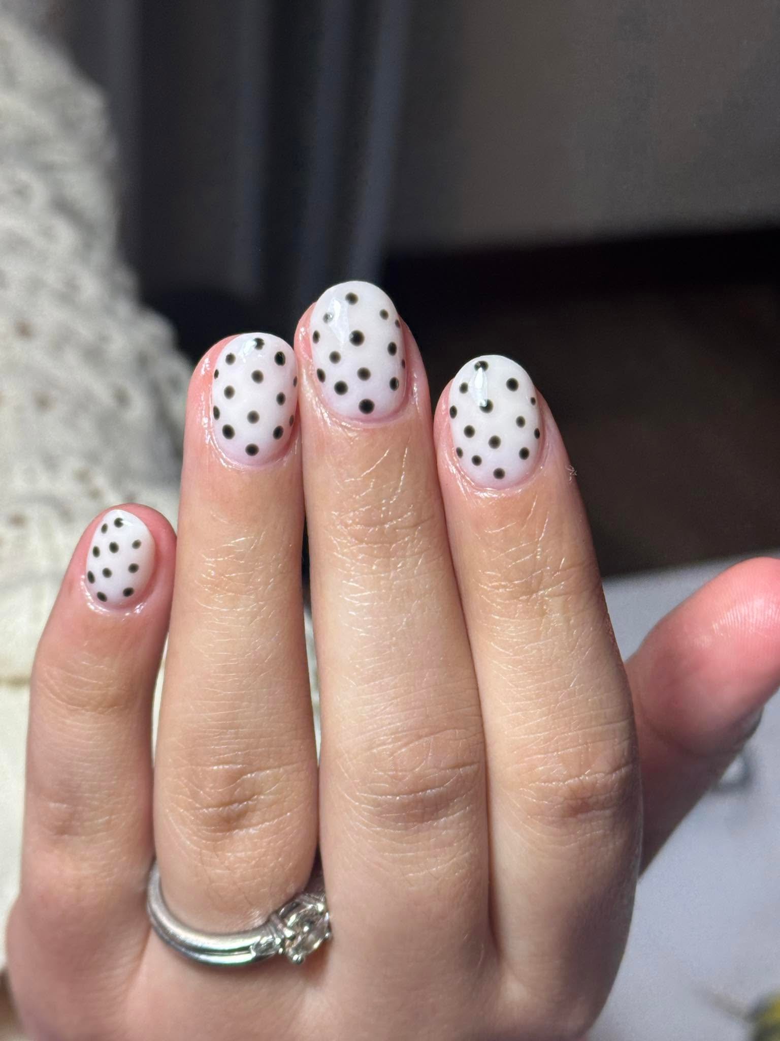 Cream nails with black polka dot nail art pattern
