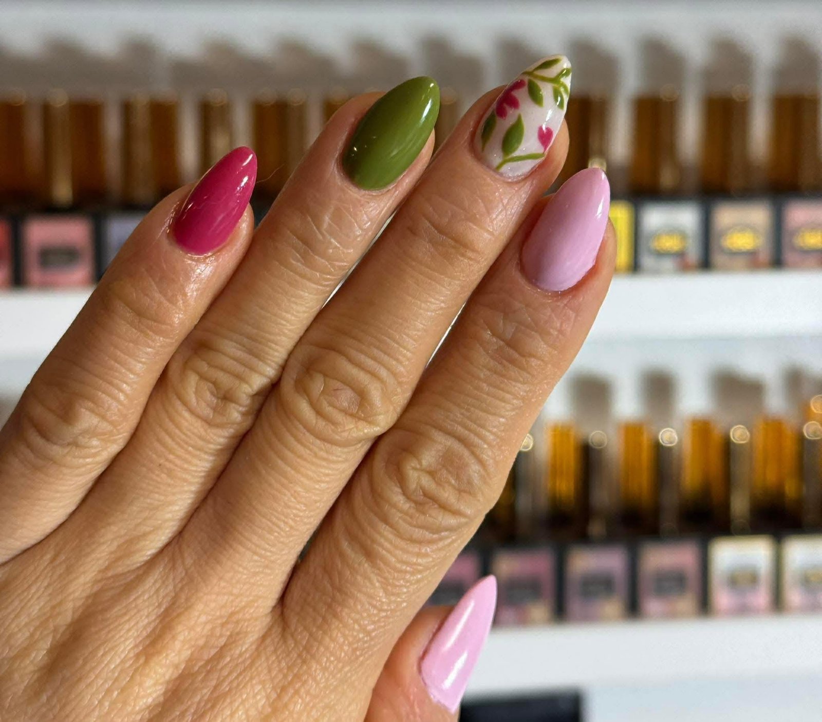 Pink, olive green and floral vine mixed manicure design