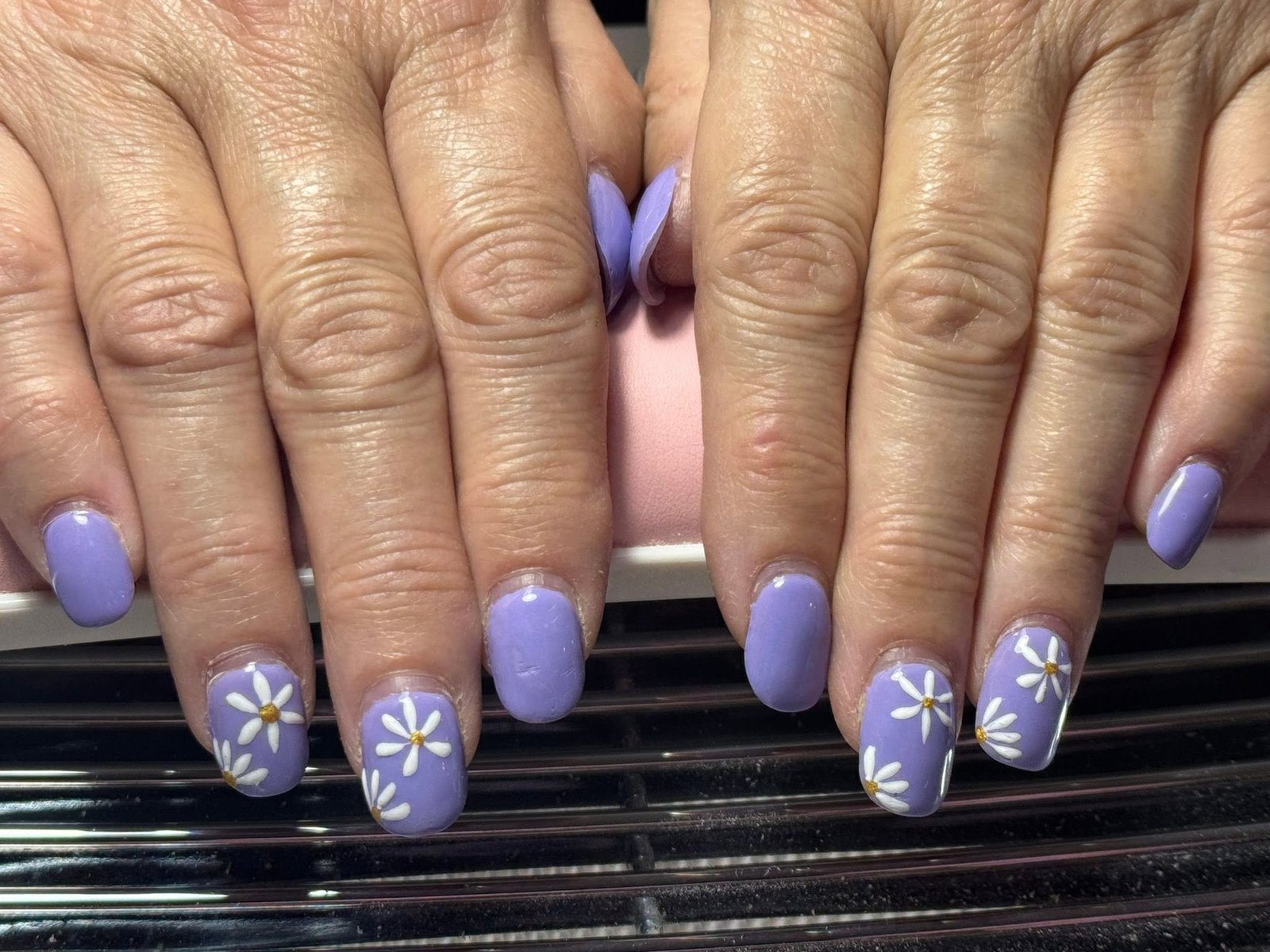 Lavender manicure with hand-painted white daisy nail art