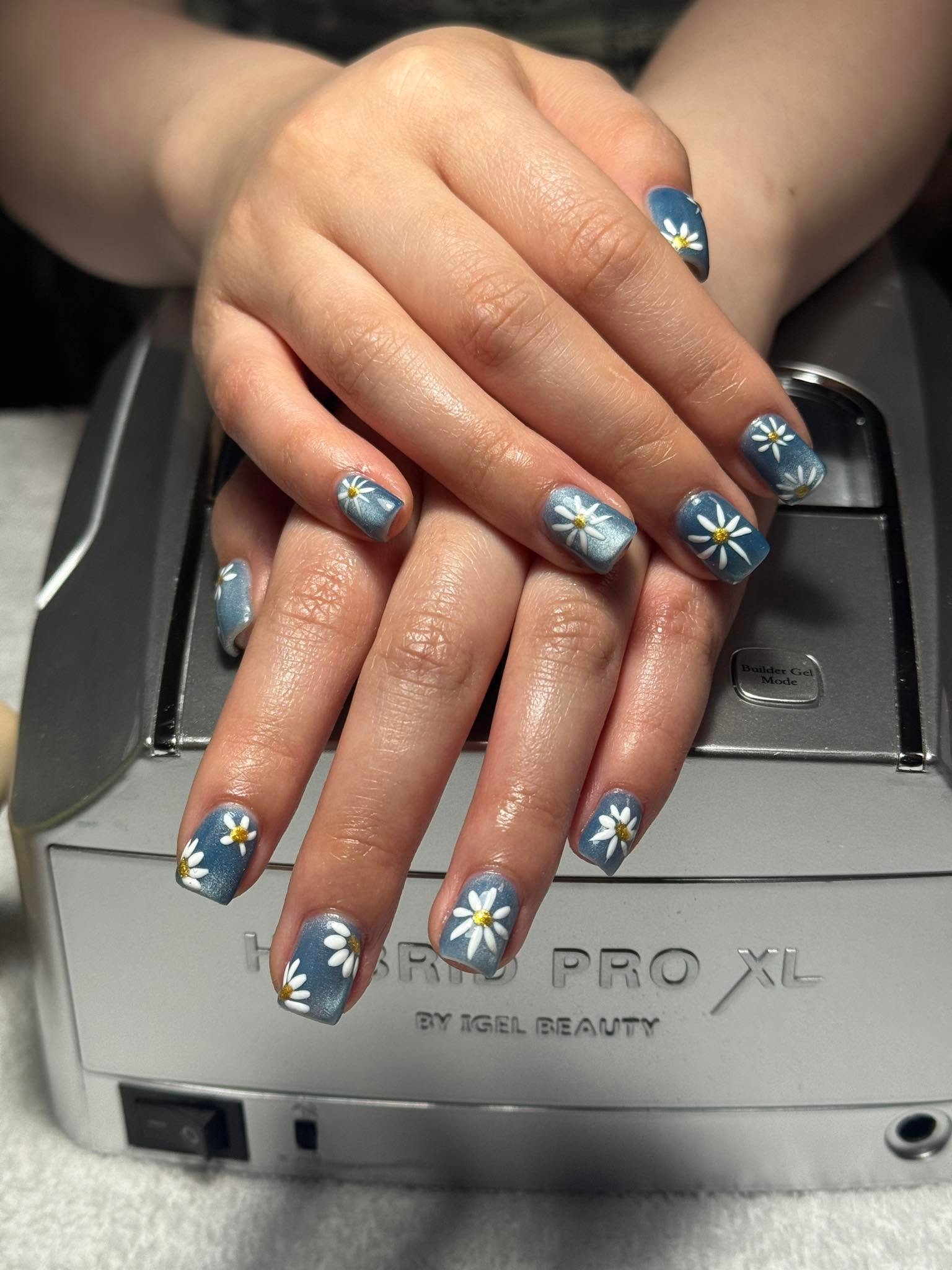 Dusty blue nails with hand-painted white daisy nail art
