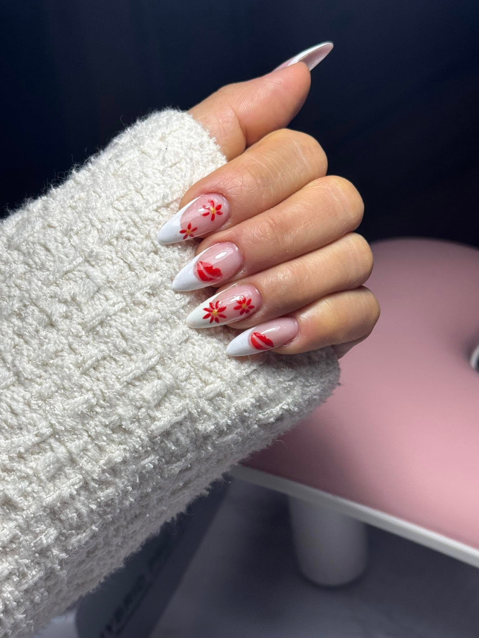 White tip nails with hand-painted red flowers