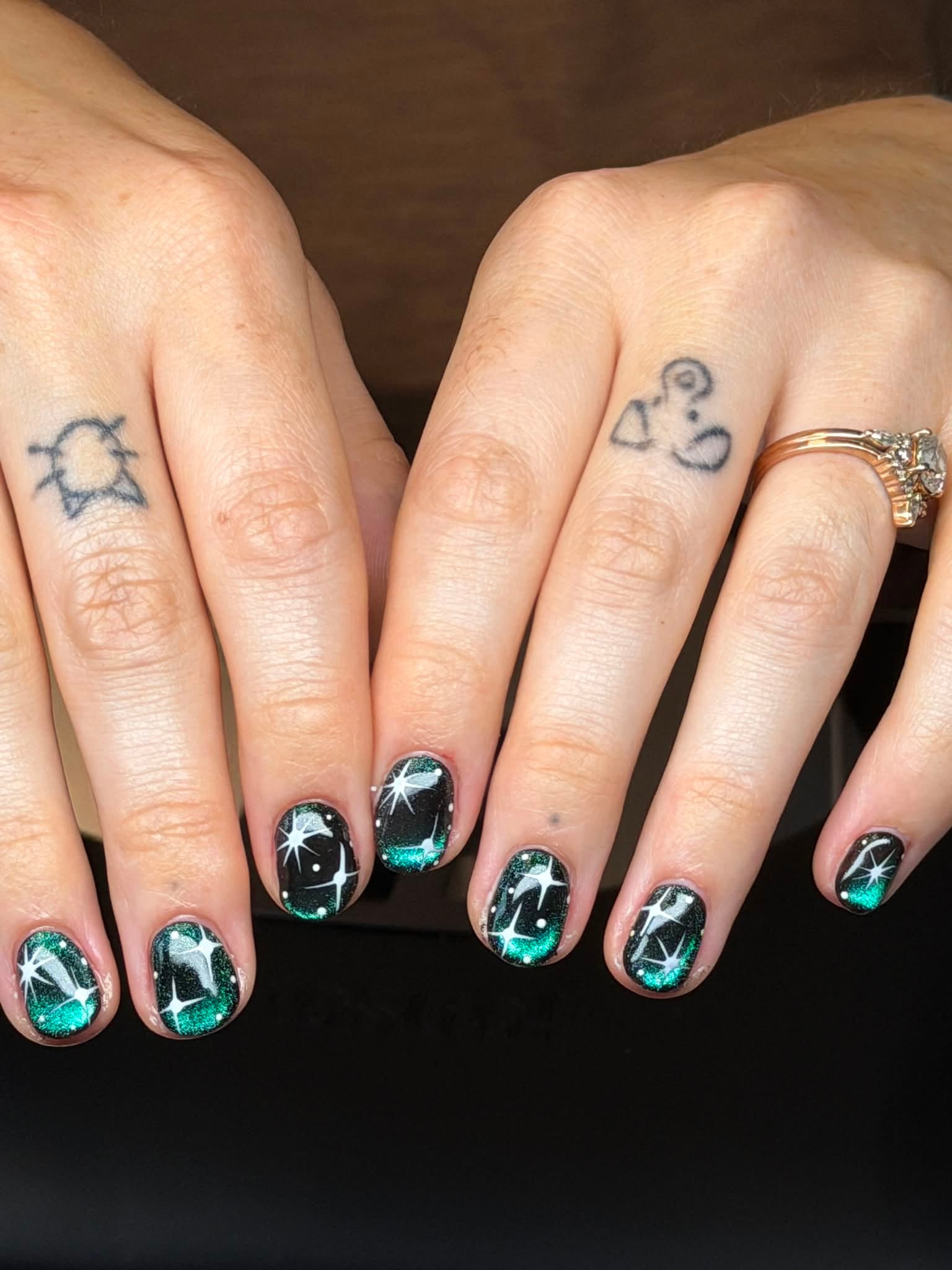 Black nails with green glitter ombre and star nail art