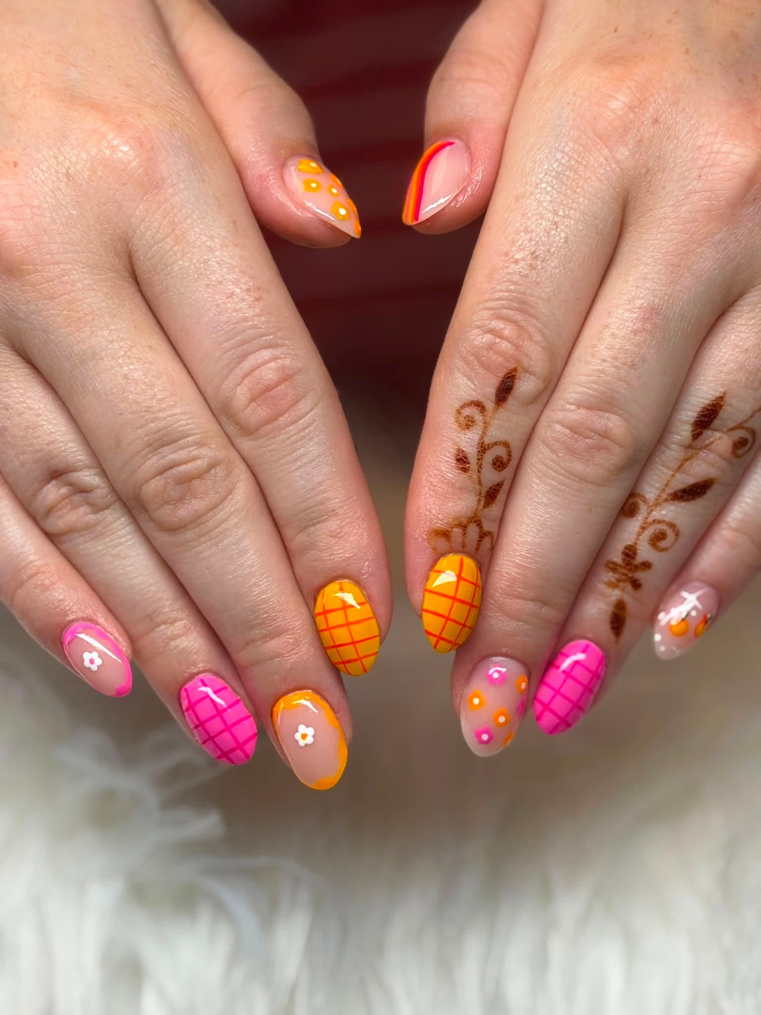 Colorful pink and orange plaid and floral nail art