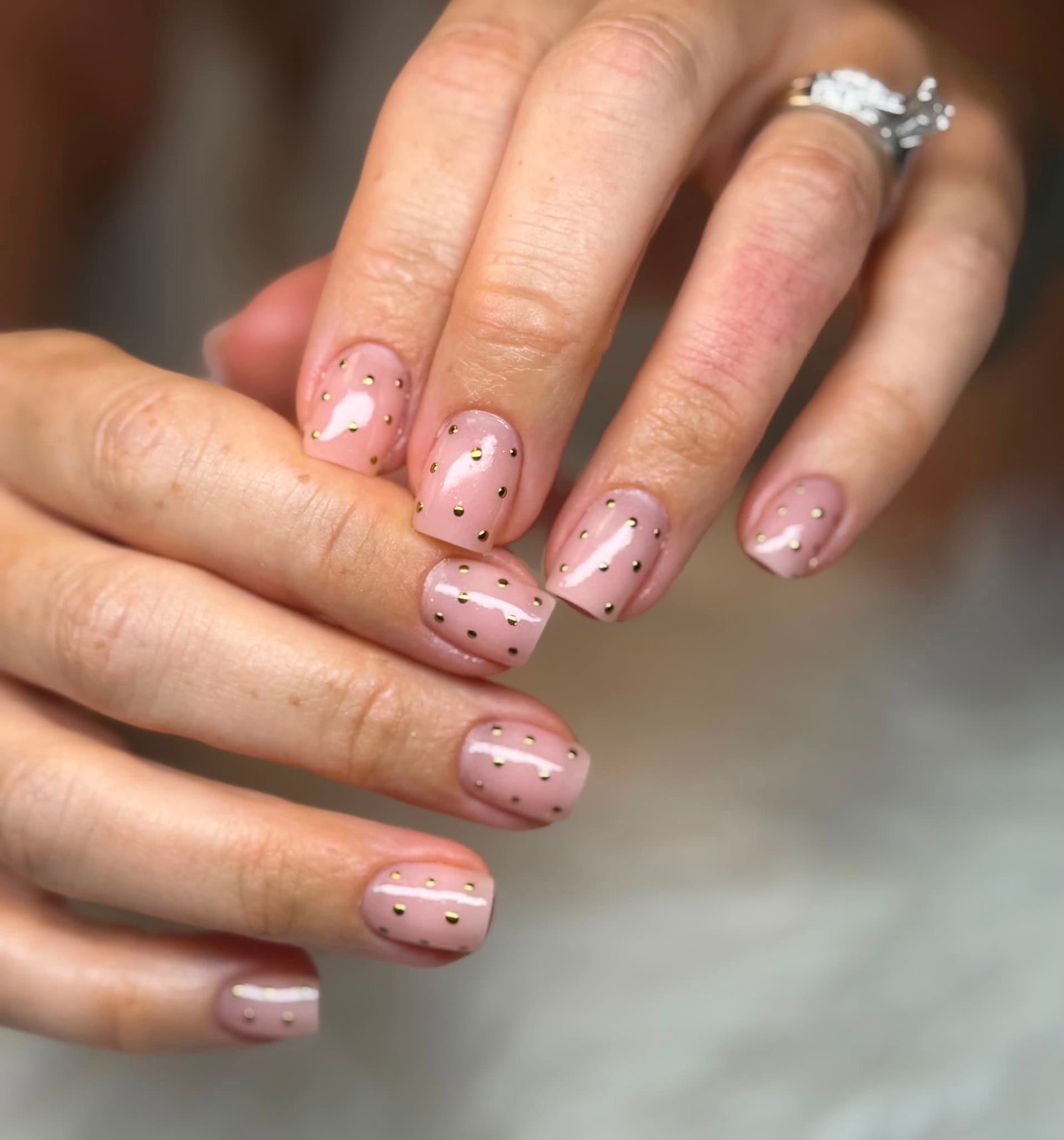 Nude manicure with gold micro-stud dots
