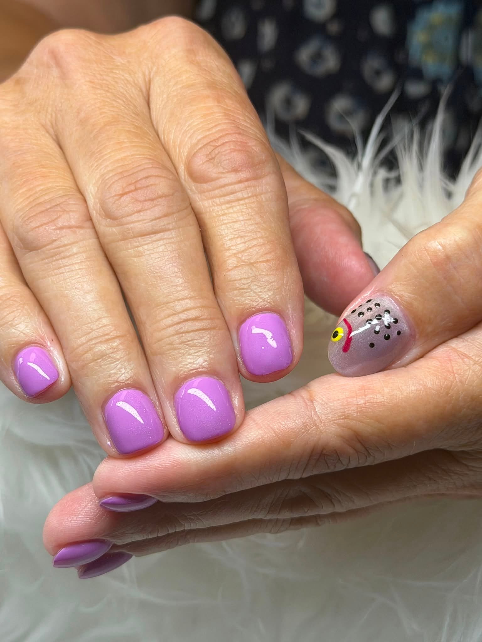 Lilac manicure with fish accent nail
