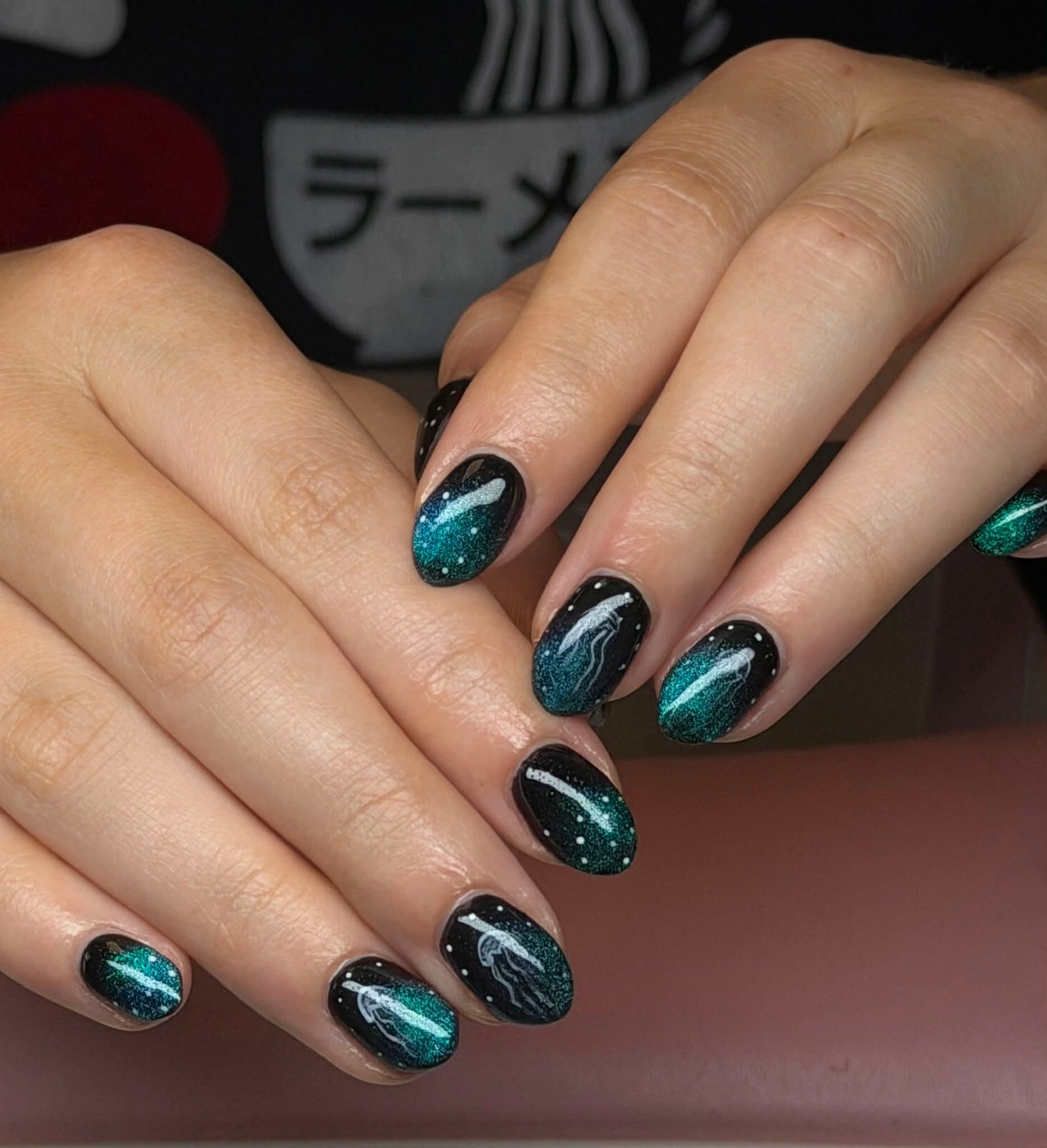 Black manicure with galaxy jellyfish design