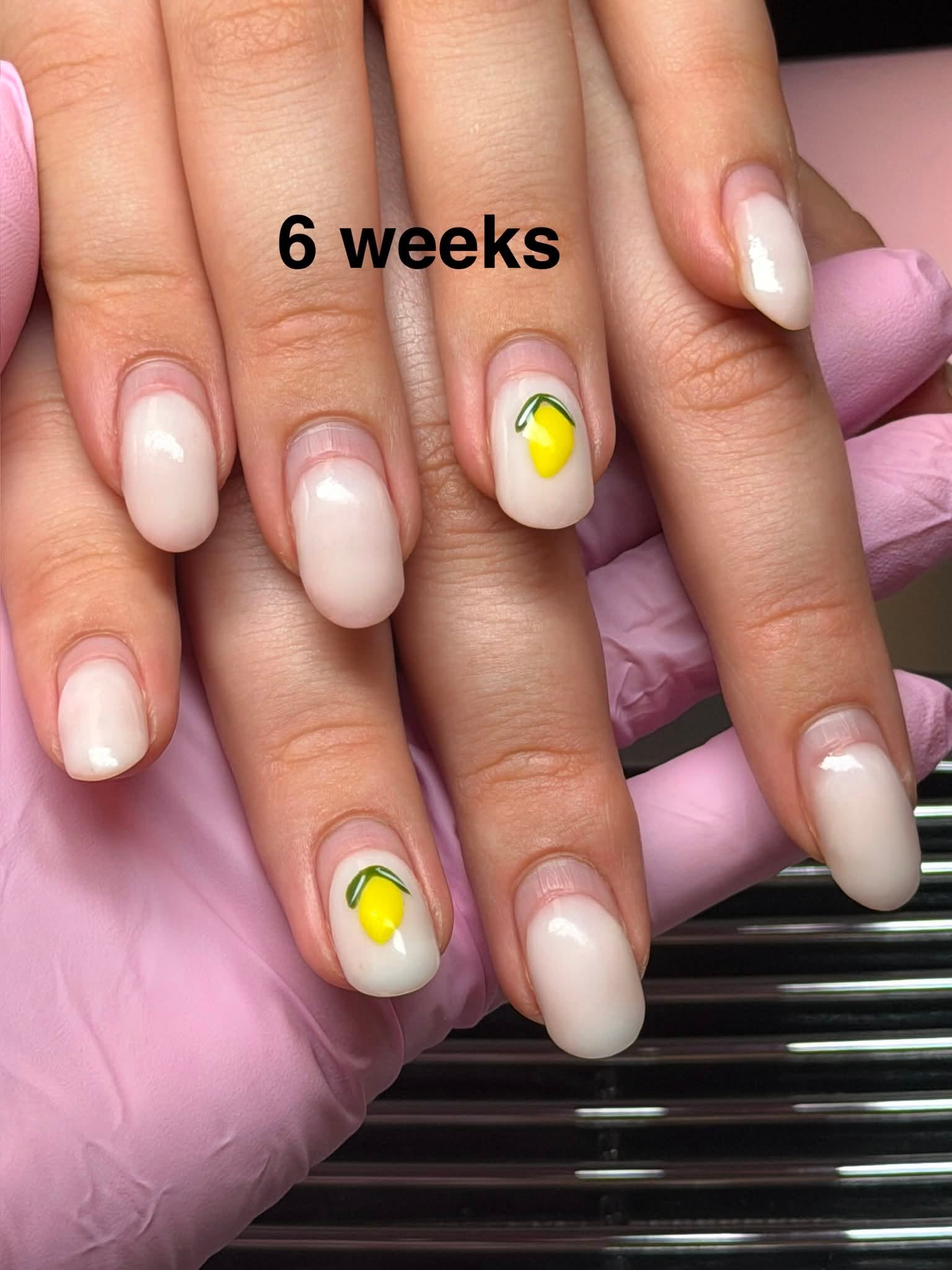 Nude manicure with painted lemon accent