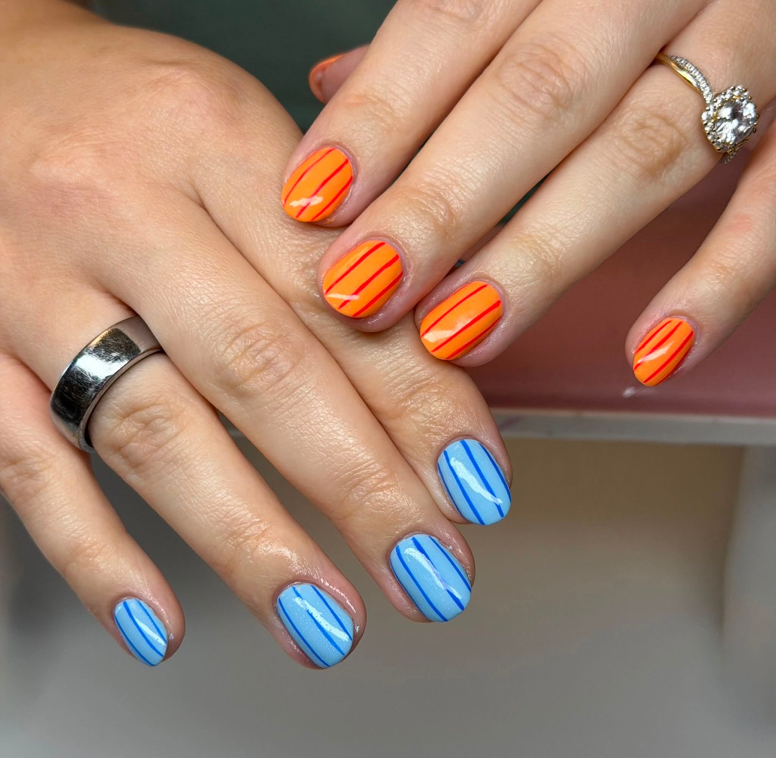 Orange and blue striped manicure