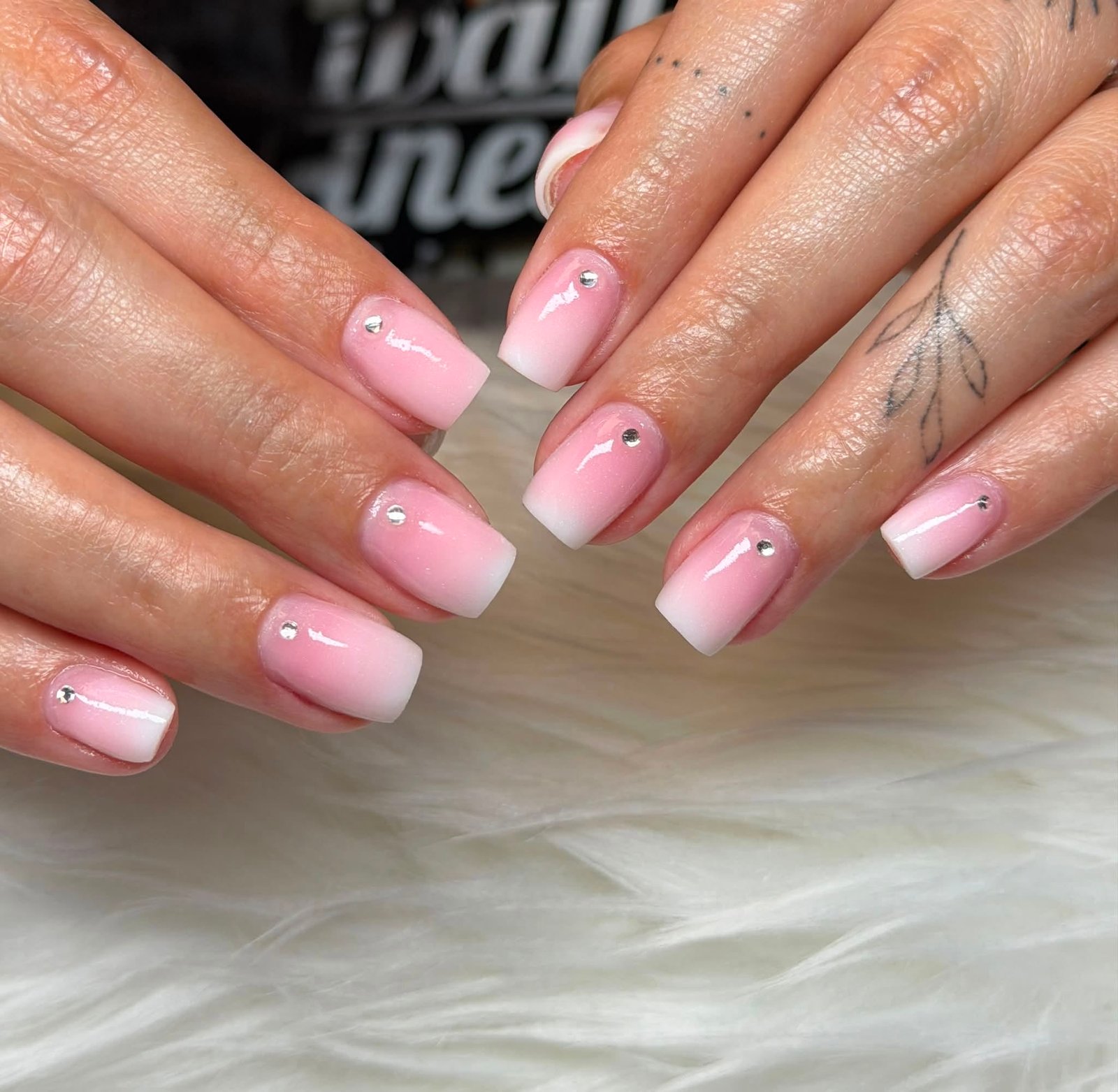 Pink ombre nails with rhinestone accents