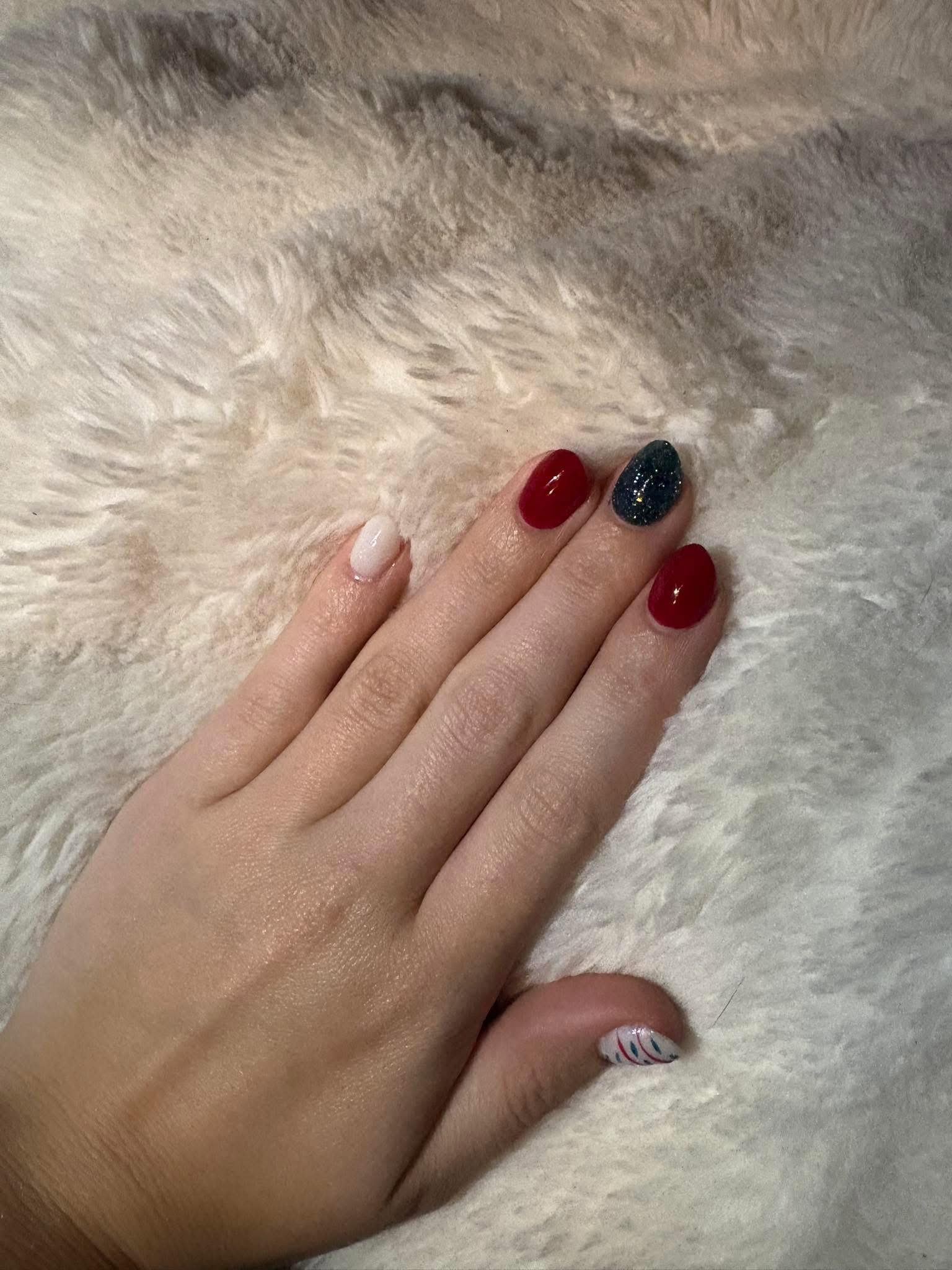 Red nails with a candy-cane striped accent nail